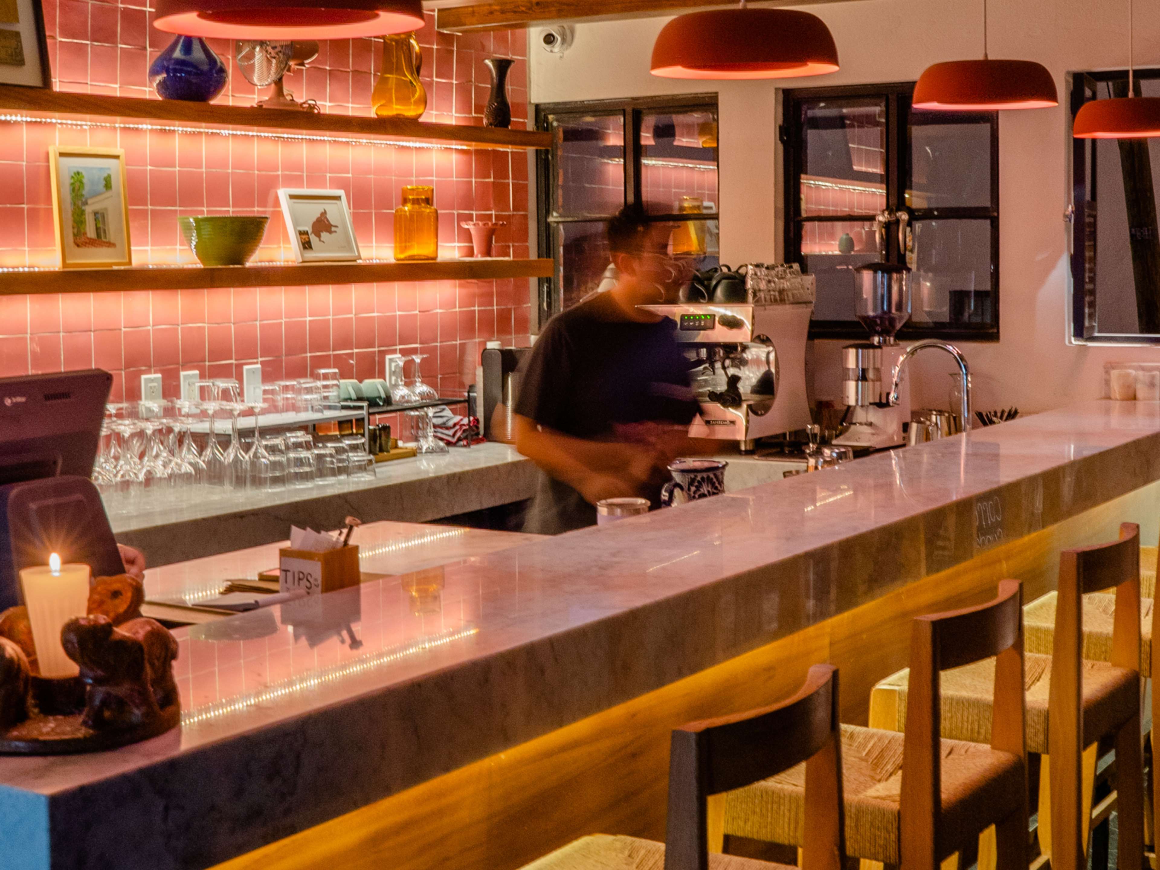 Interior bar space with pink tiled walls at La Confianza