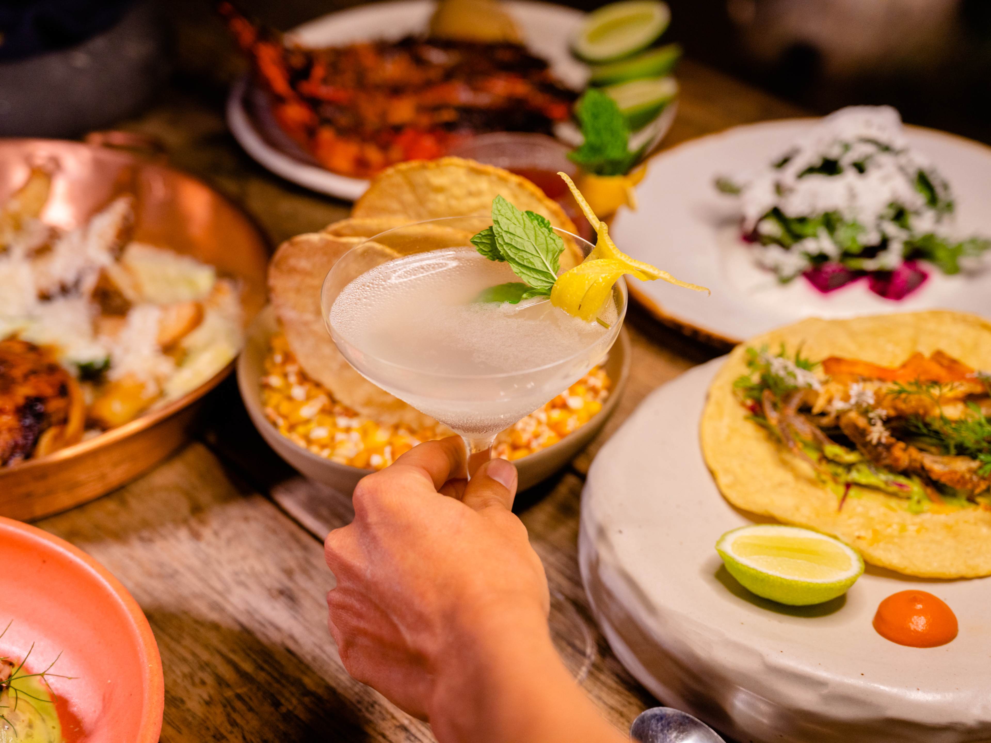 Spread of Mexican dishes and cocktails at Tenoch