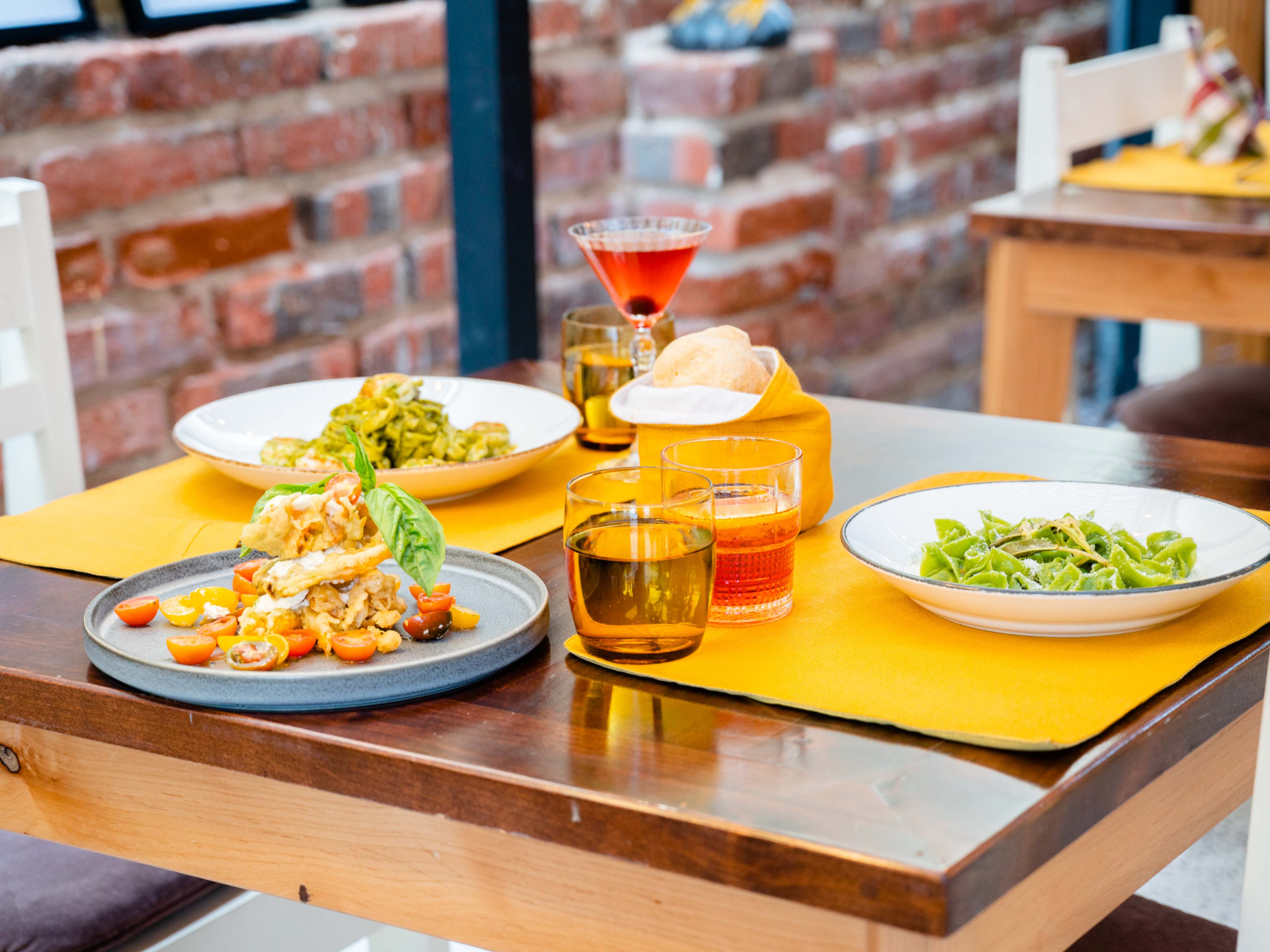 Spread of Italian dishes and cocktails at Tre Galline