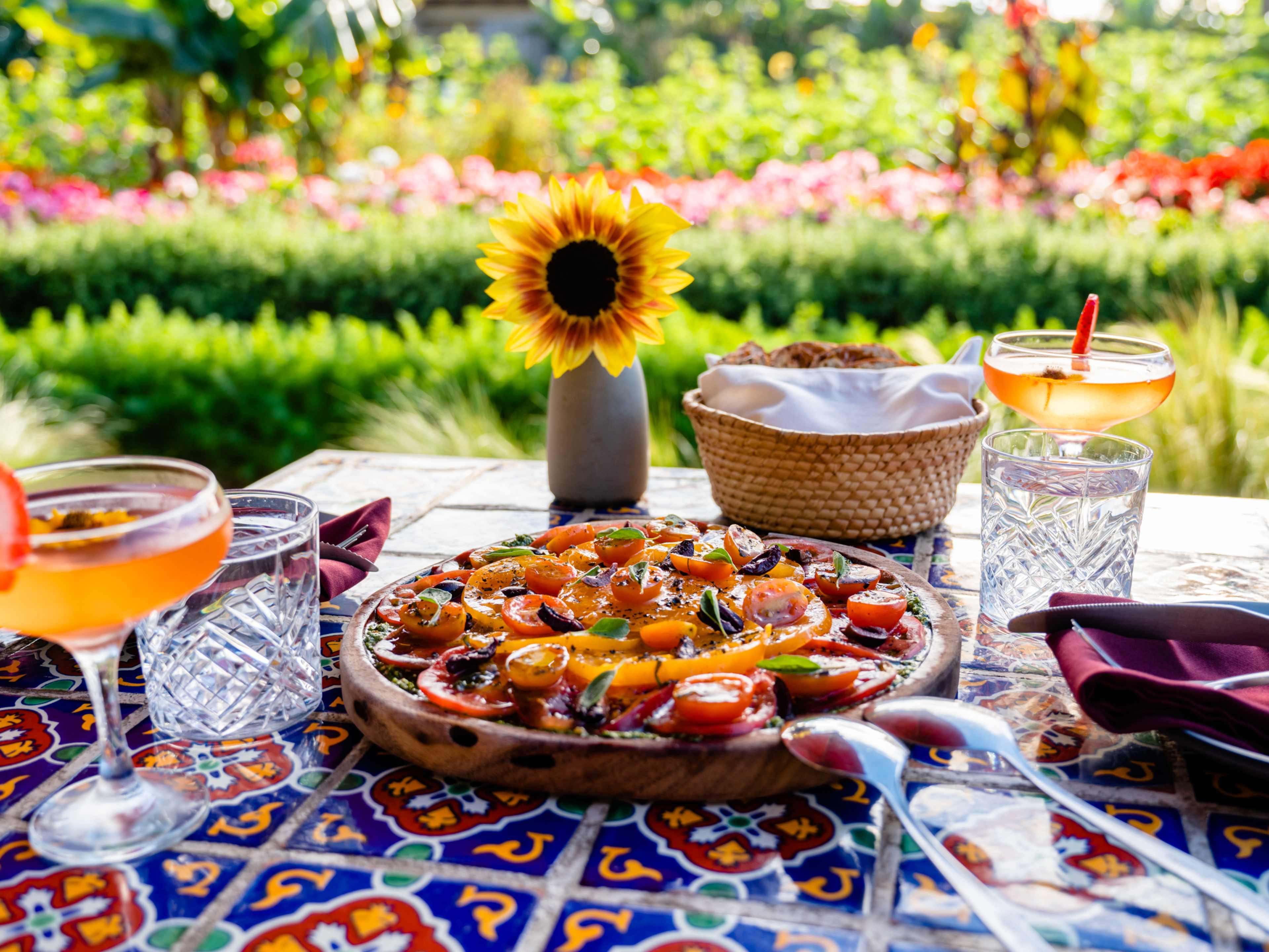 Fresh tomato dish on outdoor table at Cocina de Campo by Agricole