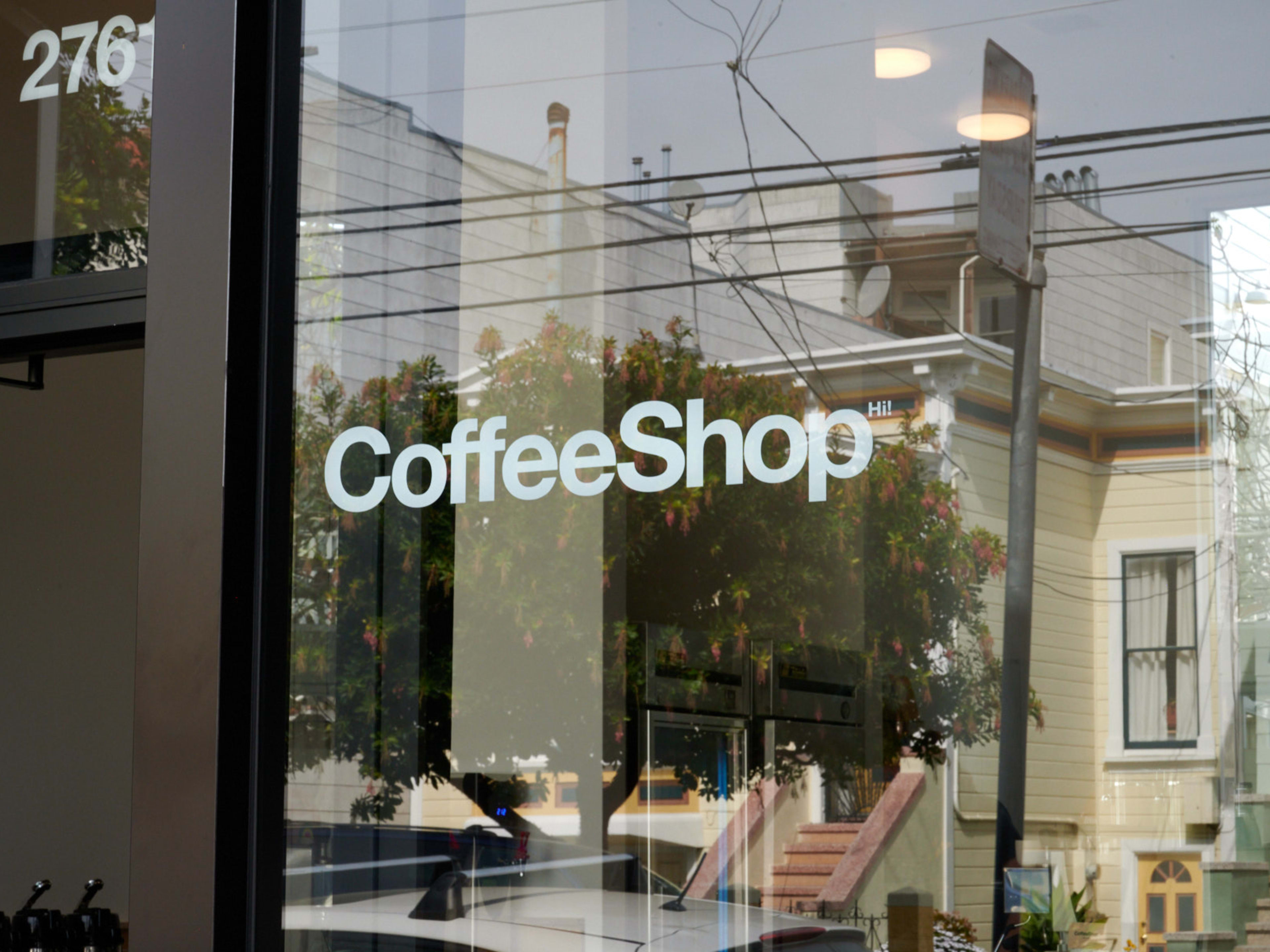 coffeeshop exterior with big window displaying logo