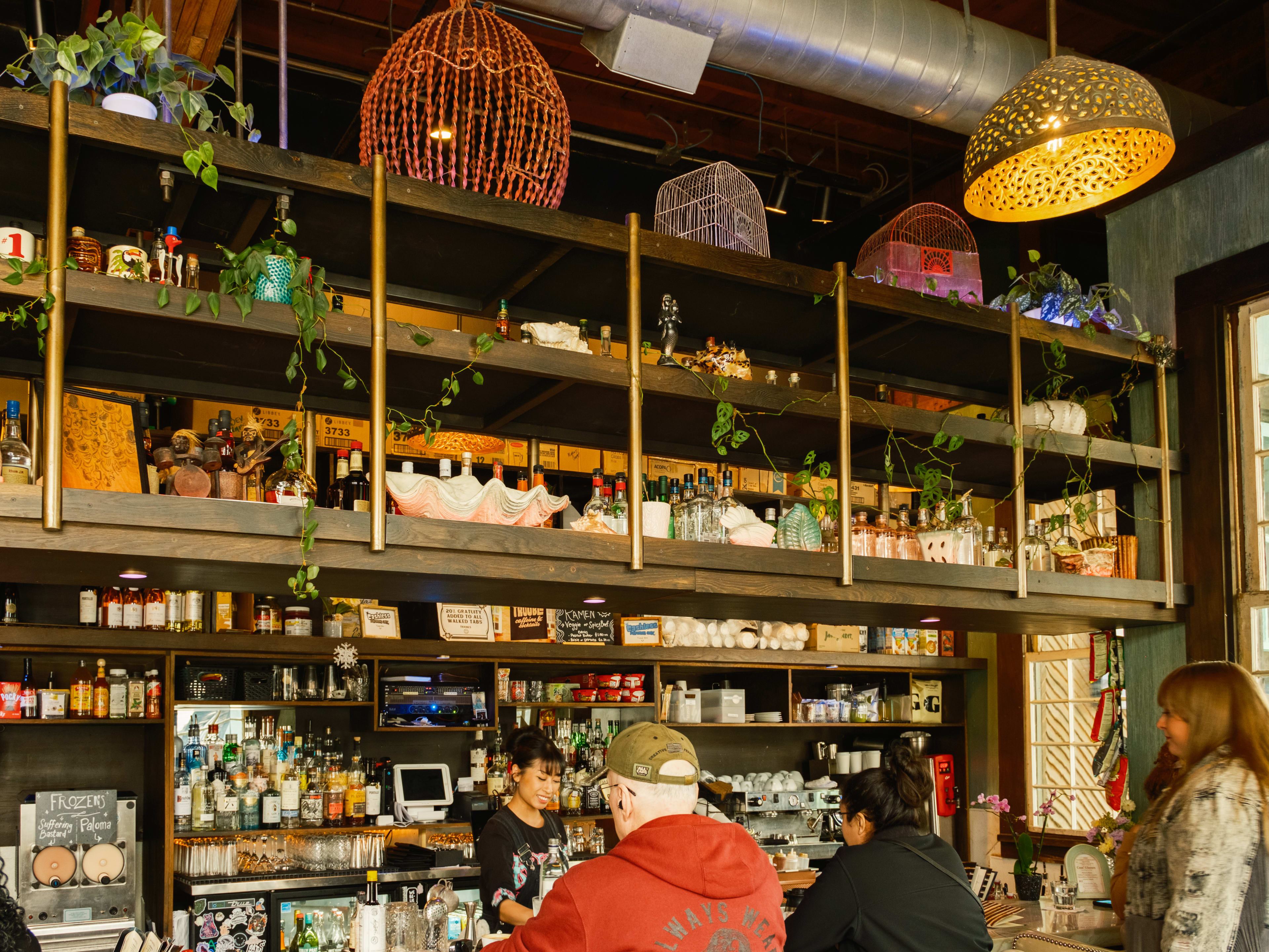 People sitting at the tiki inspired bar at Double Trouble.