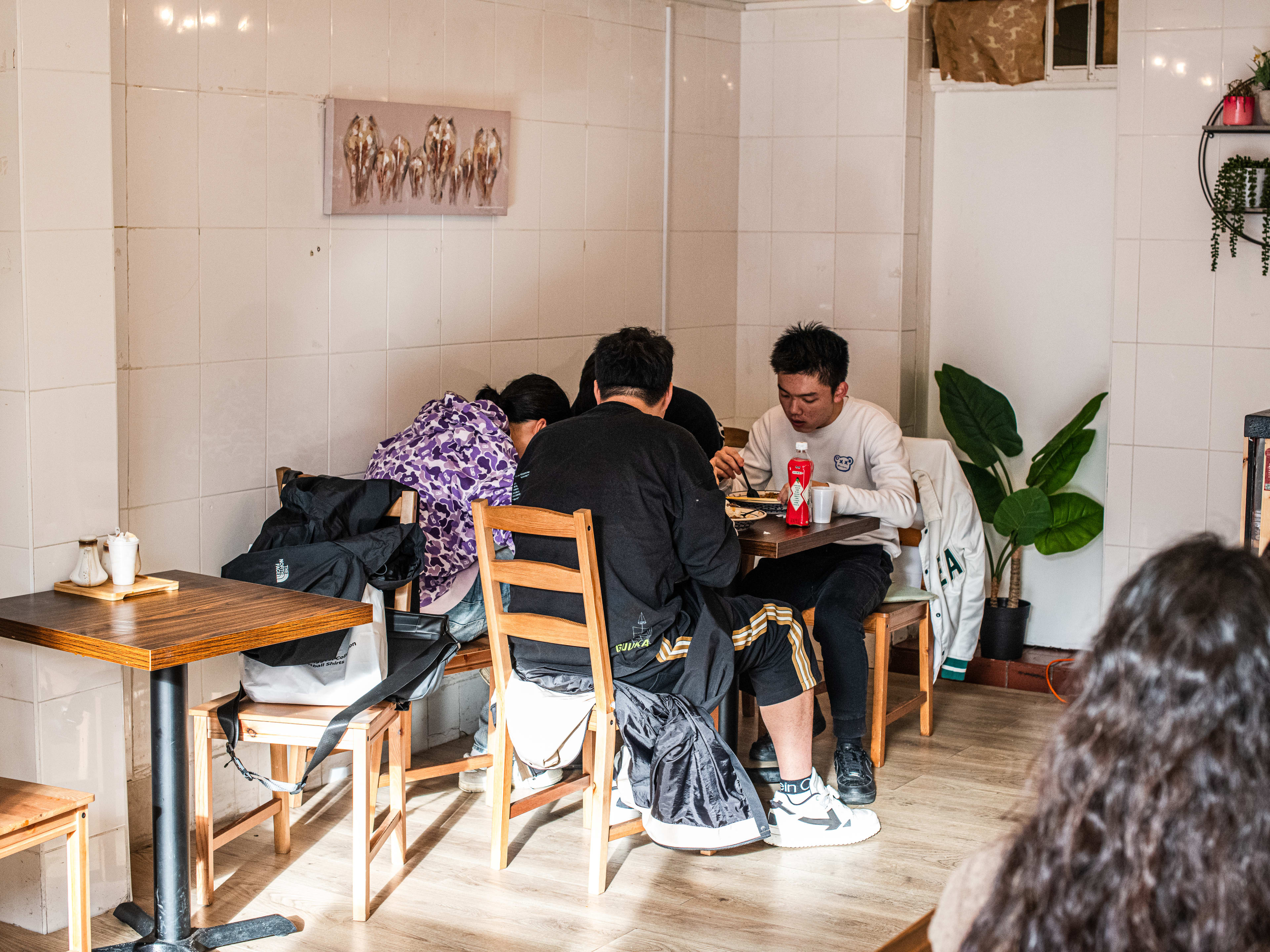 People dine at a table at Dr.Noodle.