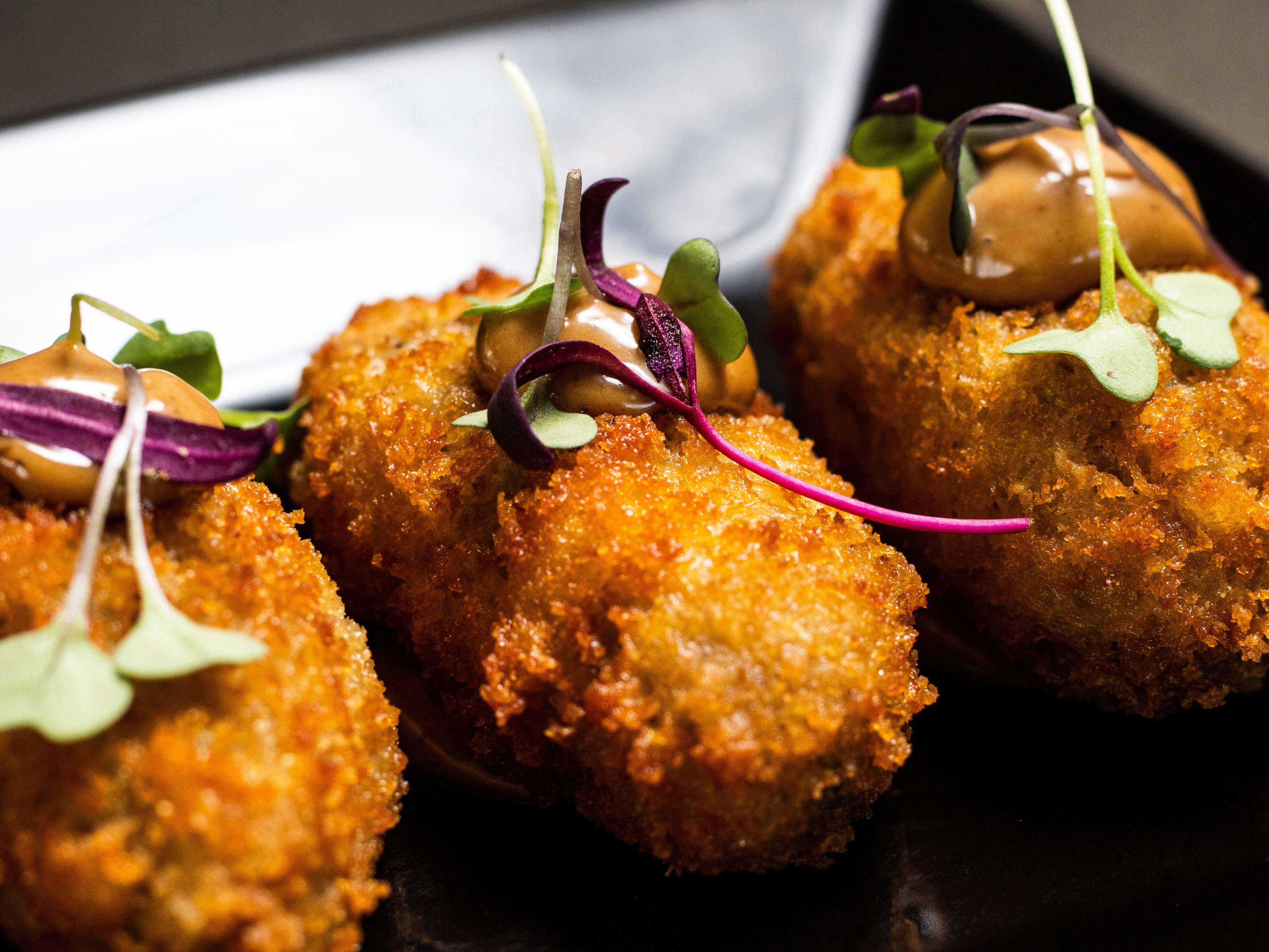 A close shot of crispy croquetas.