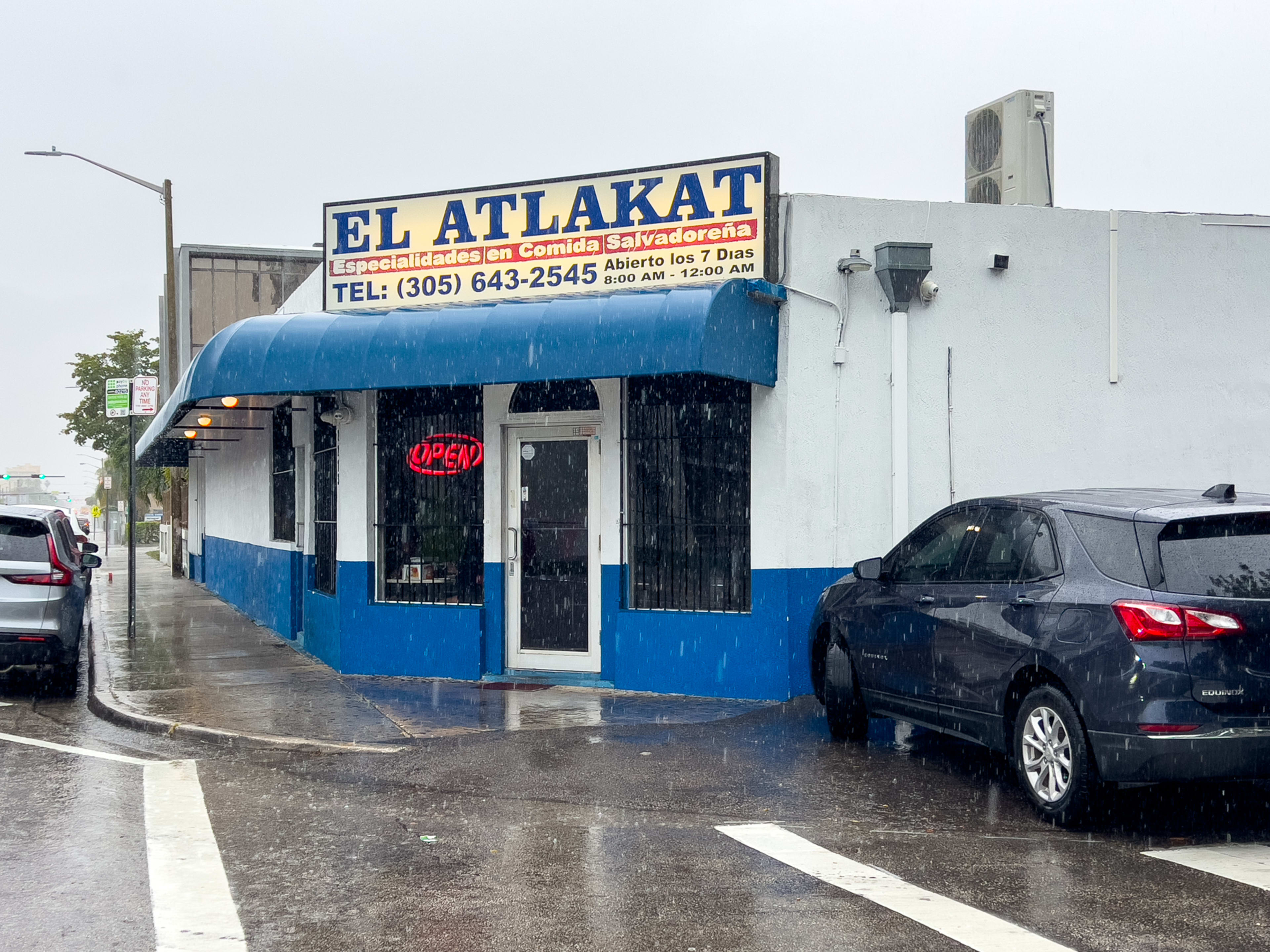 Blue and white restaurant exterior on a rainy day