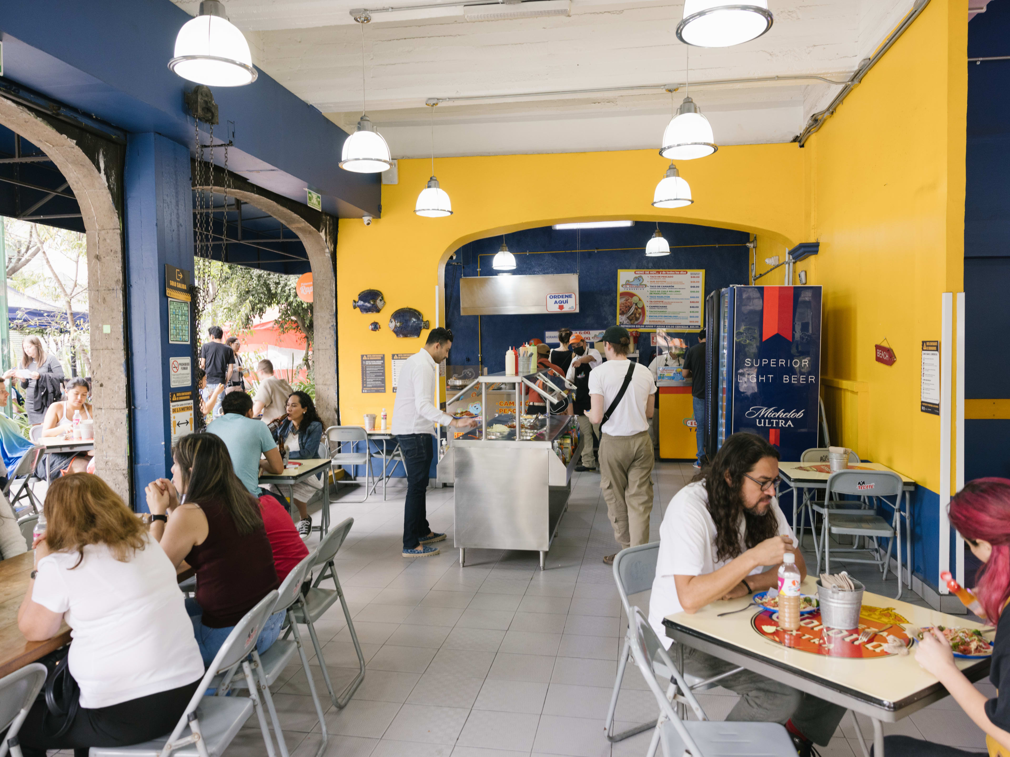 The yellow and blue interior of El Pescadito in Mexico City.