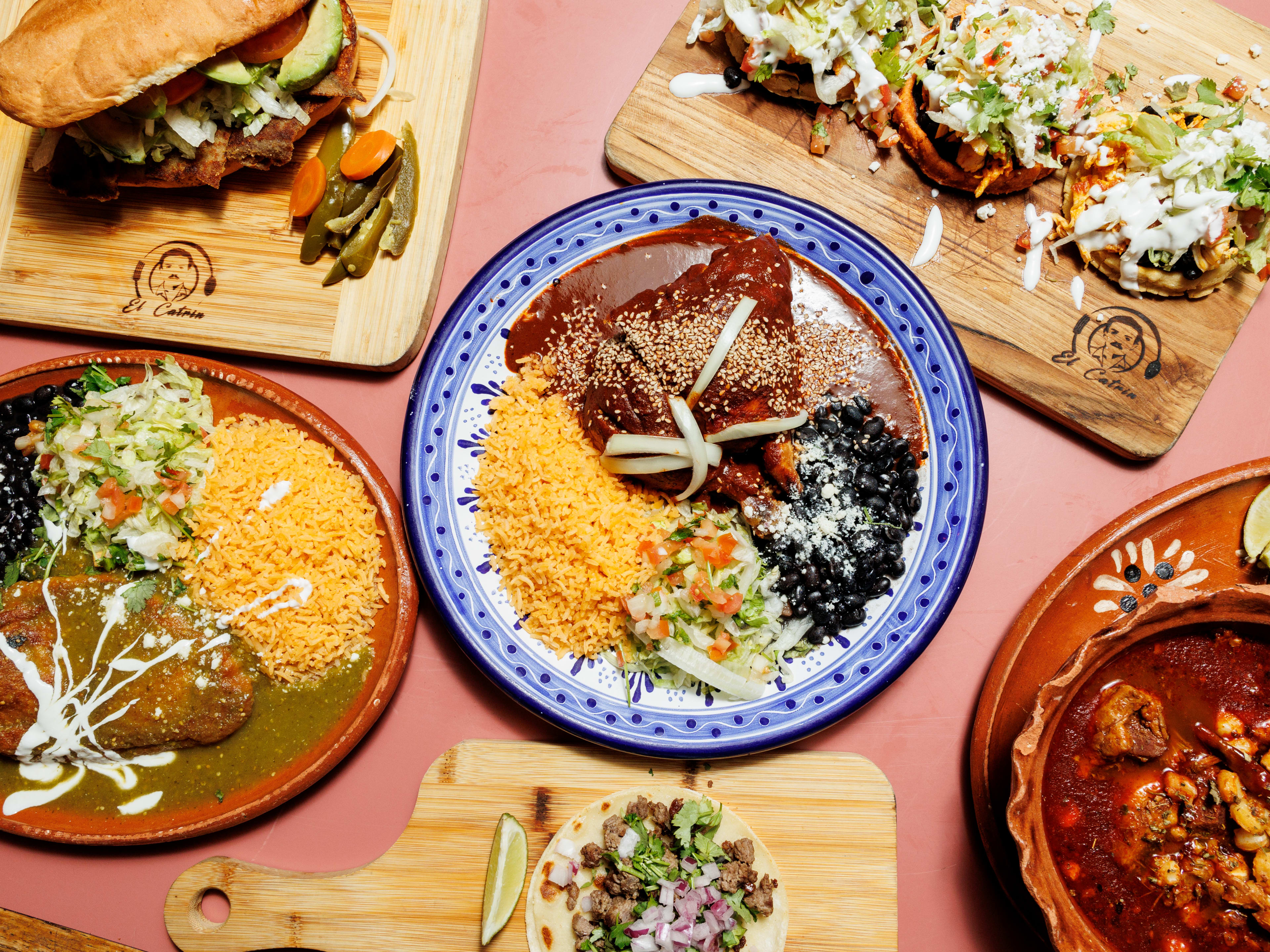 spread of chile rellenos, chicken mole, spicy pork torta, and pozole