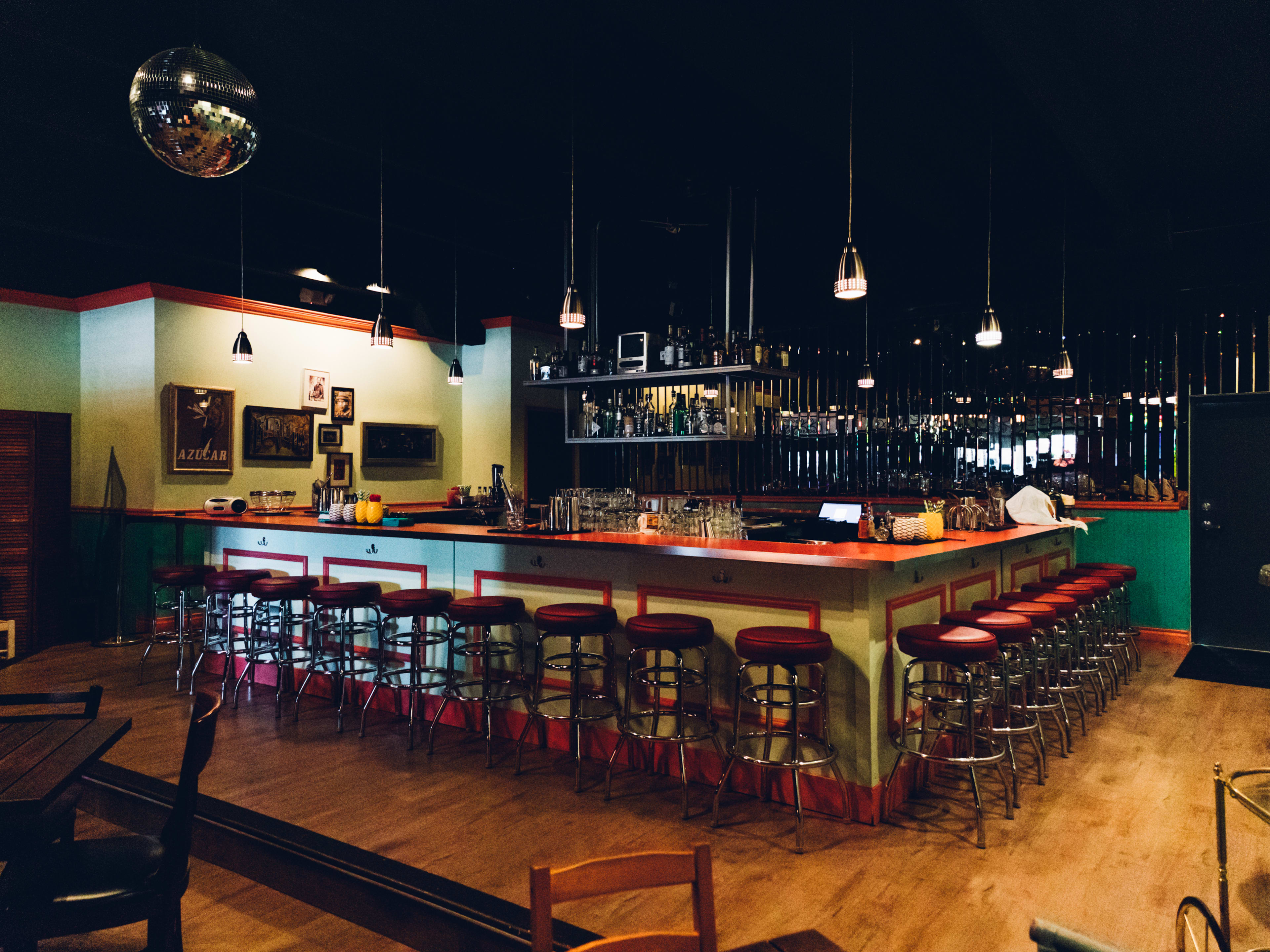 A dark bar in front of a mirrored wall.