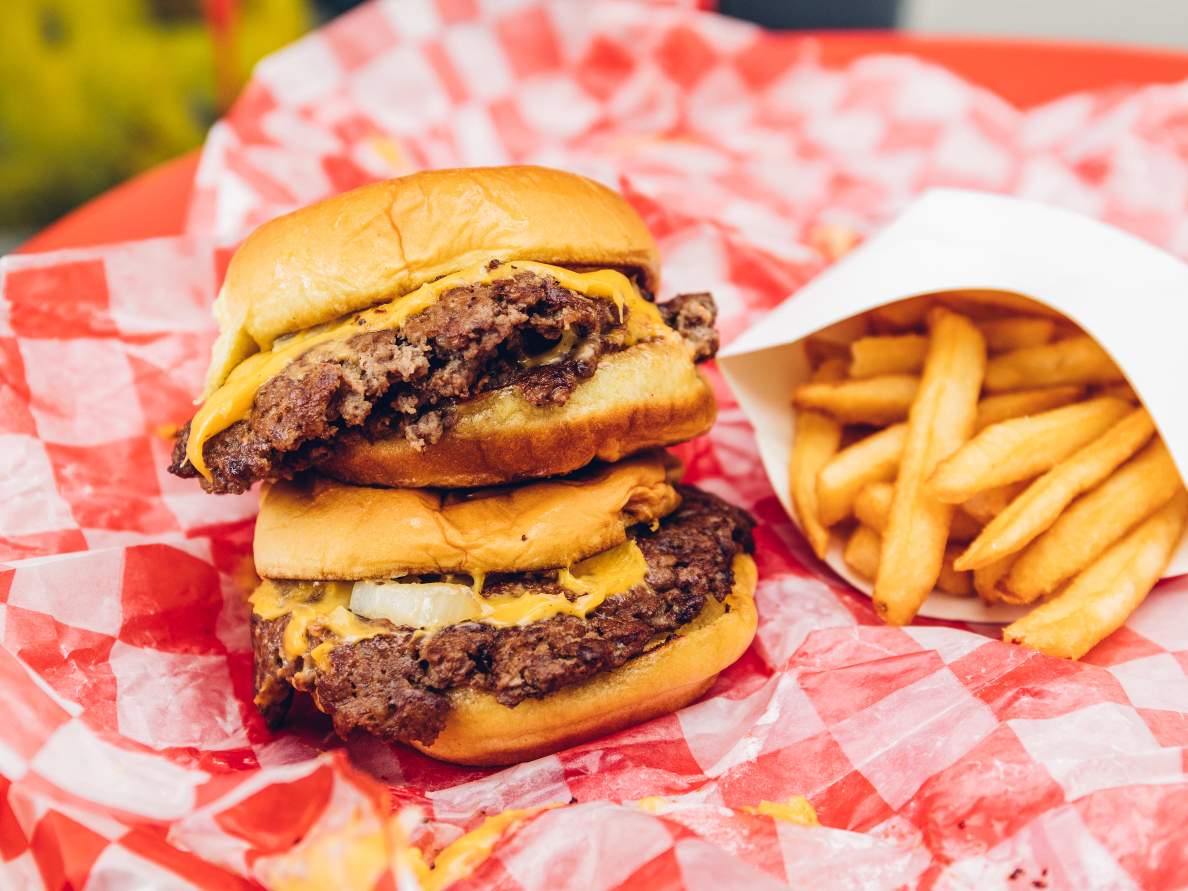 Two smashburgers with a side of fries.