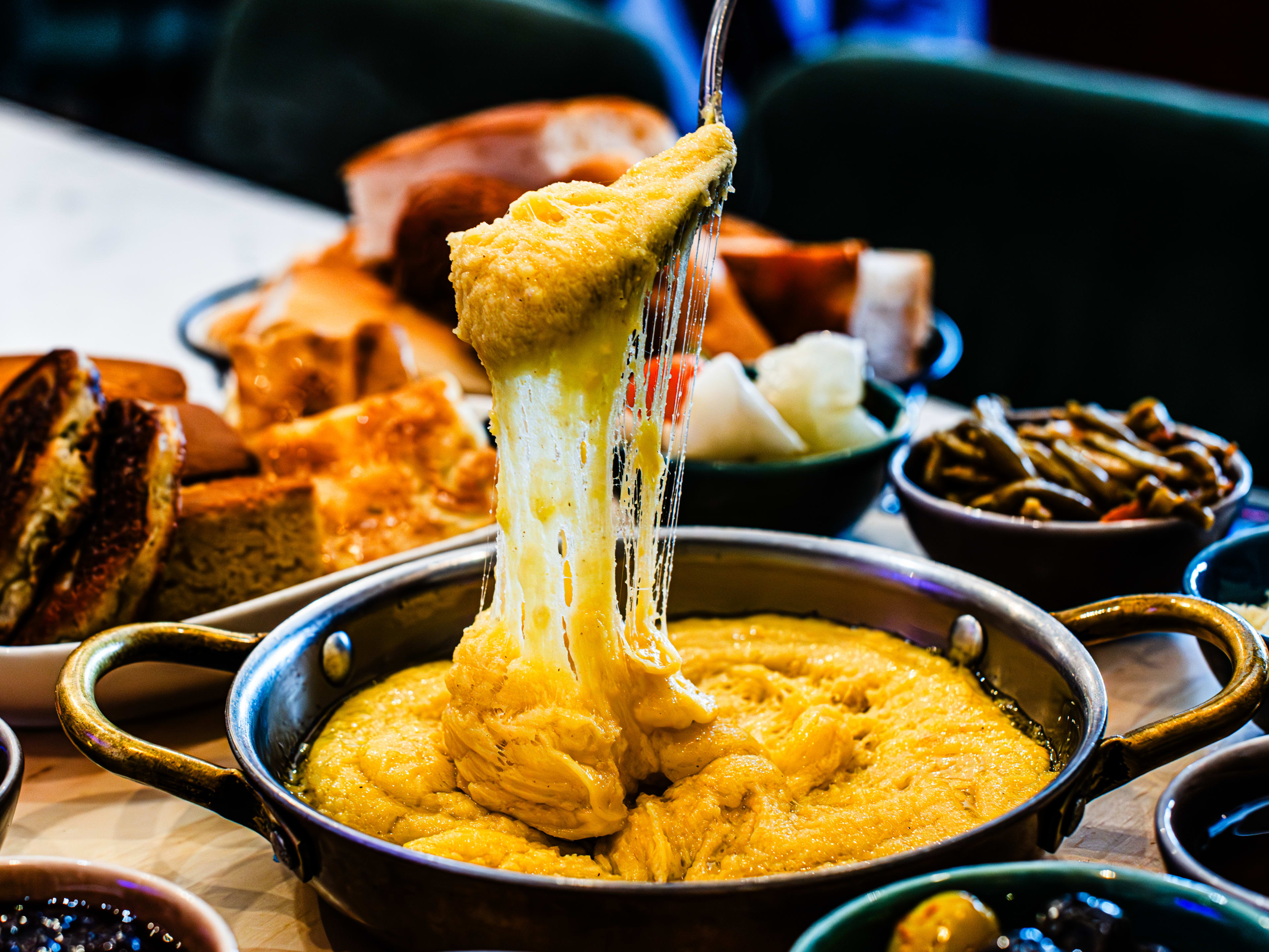 The cheese pull of the Karadeniz Breakfast at Emy's Kitchen.