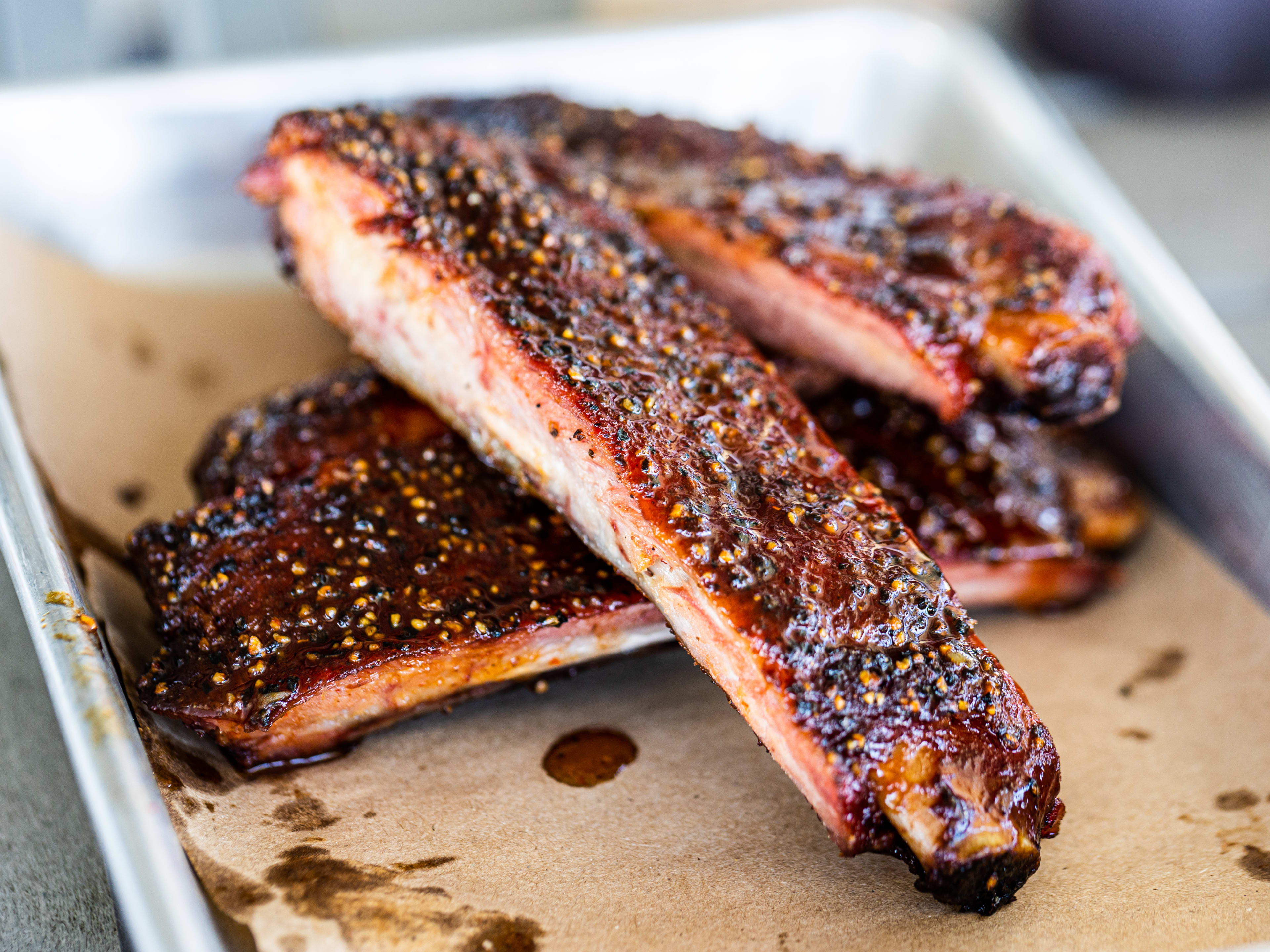 Ribs from Feges BBQ on a metal tray.