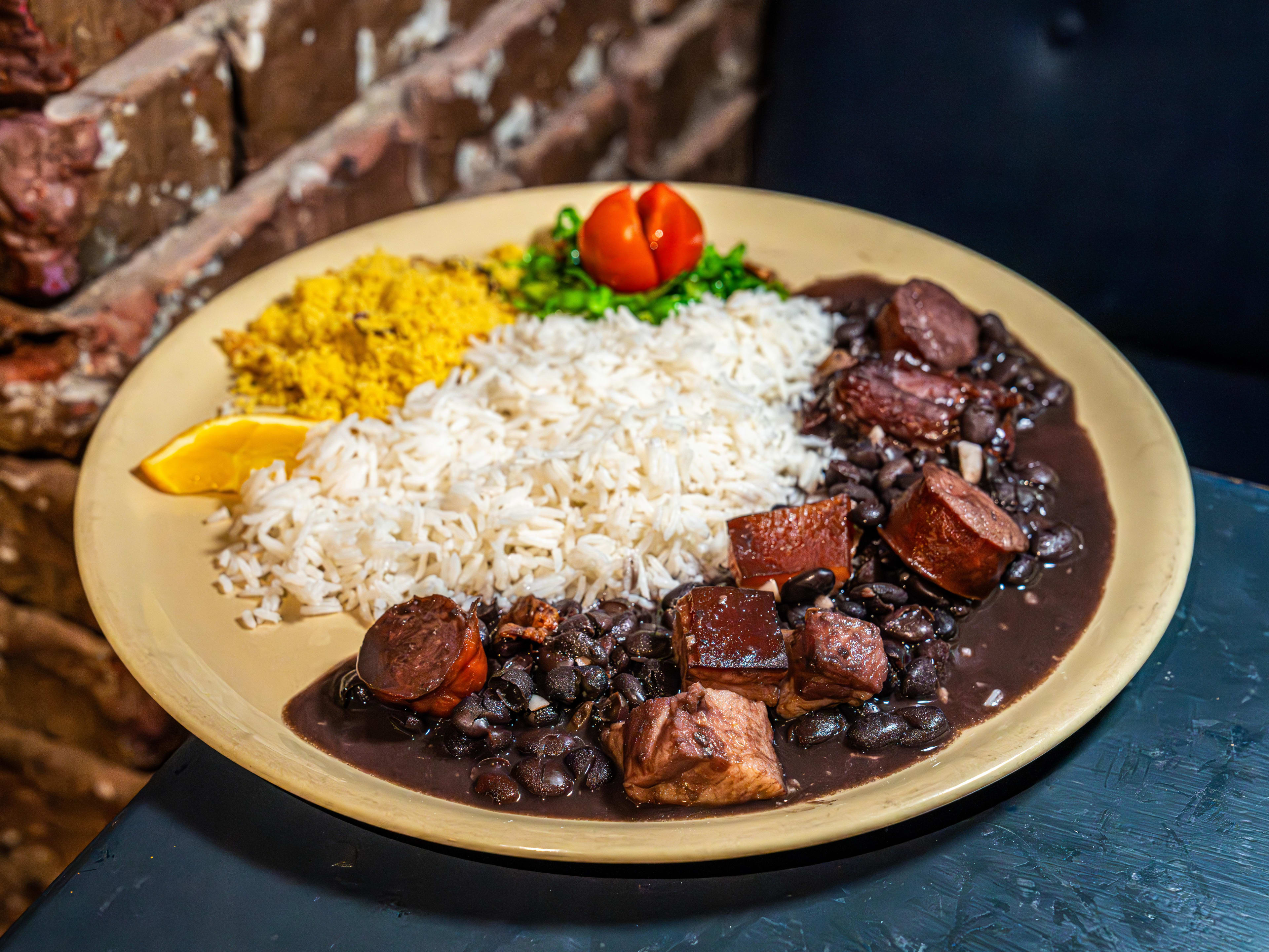 Plate of feijoada (sausage and pork ribs in sauce), with rice.