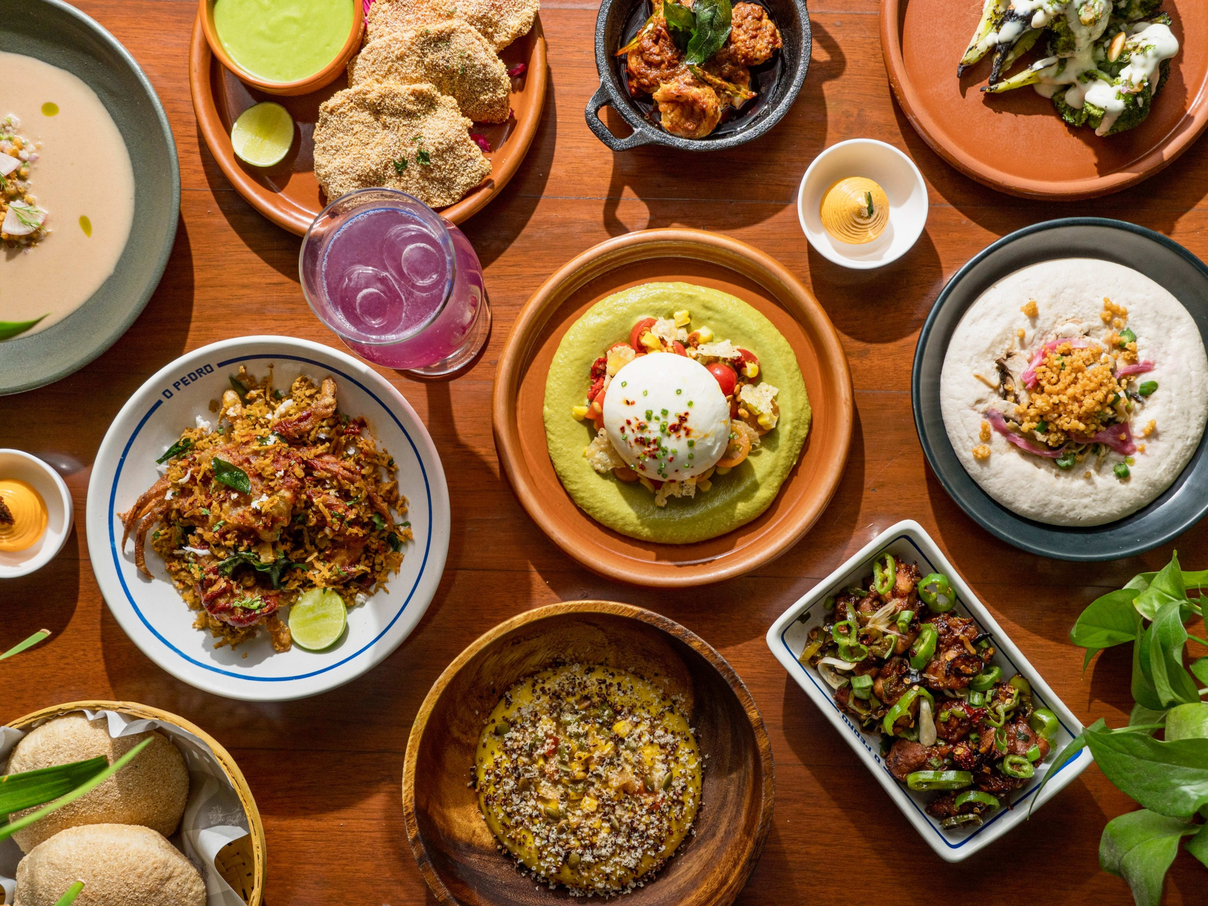 Spread of signature dishes and cocktails at O Pedro