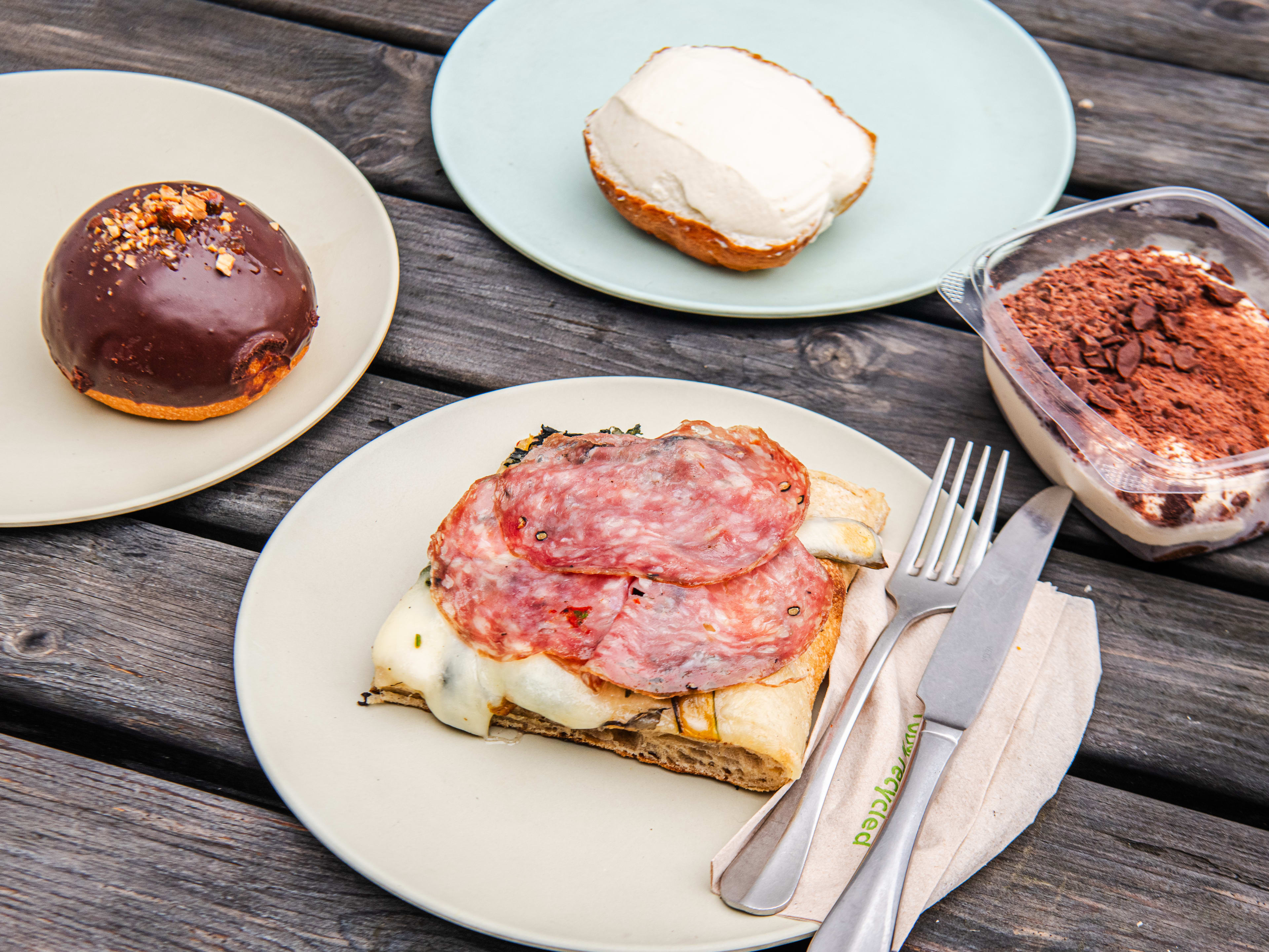 A spread of dishes on a patio picnic table at Forno.