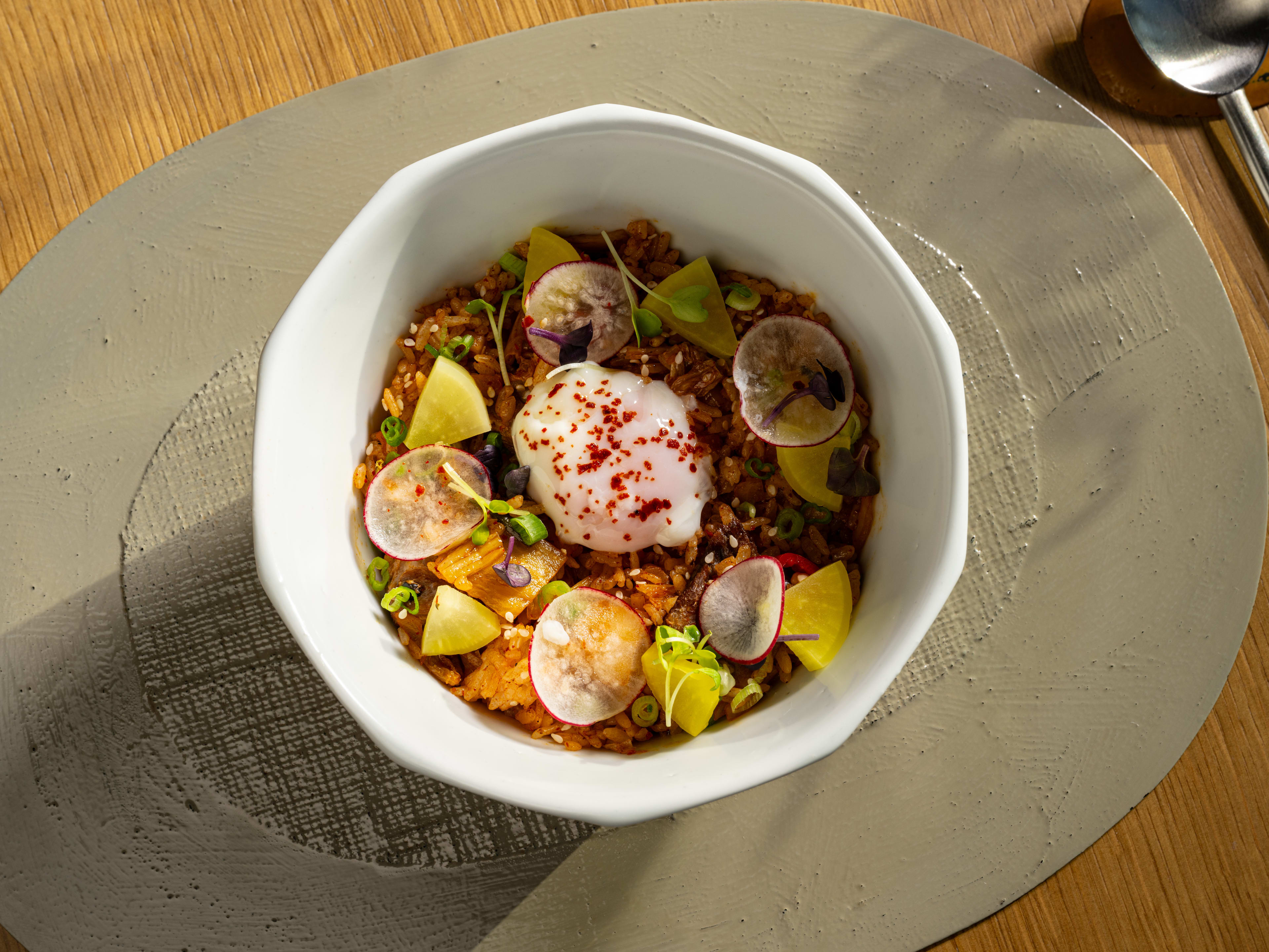 Chaeso gesalbap in a white bowl on a table.