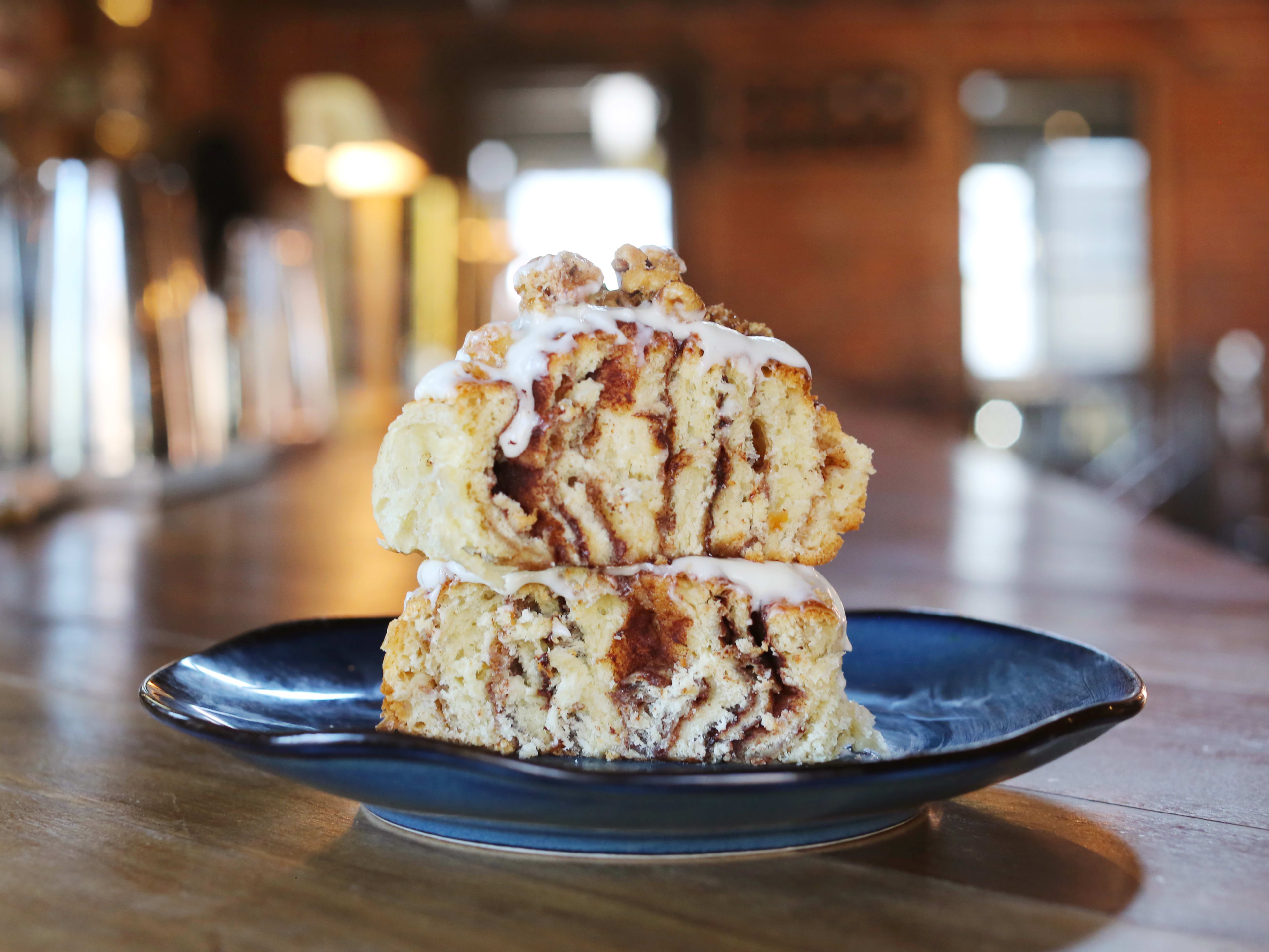 A huge cinnamon roll on a table at Geist in Nashville