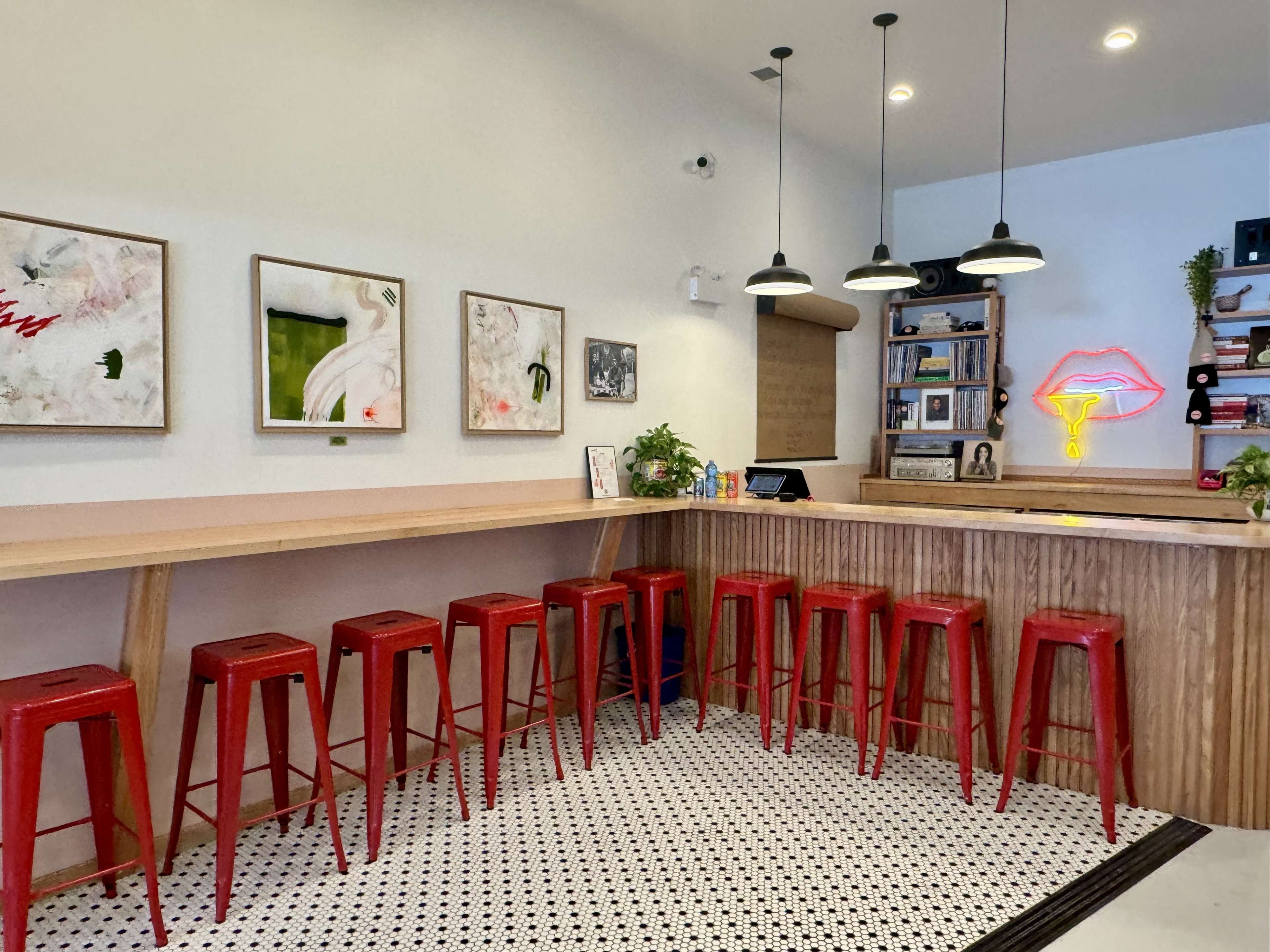 L-shaped wooden lunch counter with bright red bar stools