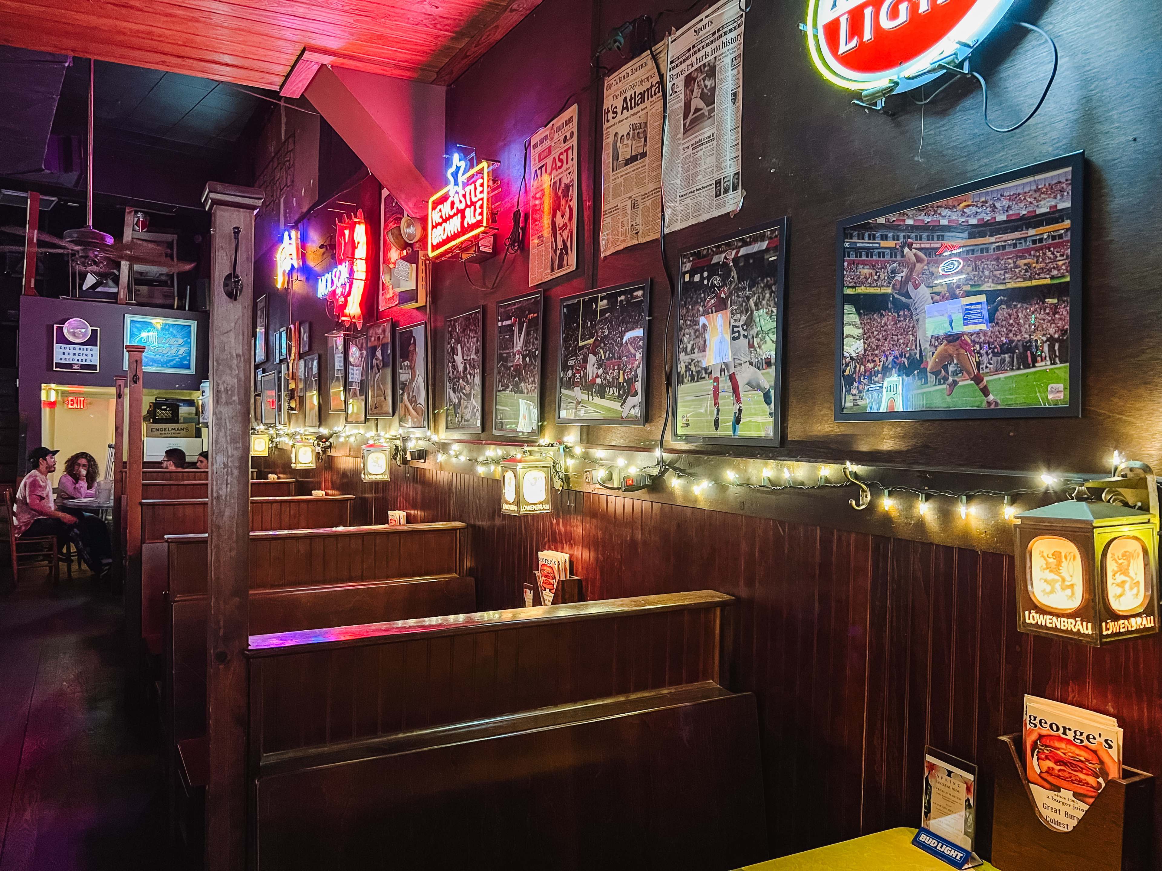 Wooden booths and neon signs in the interior of George's.