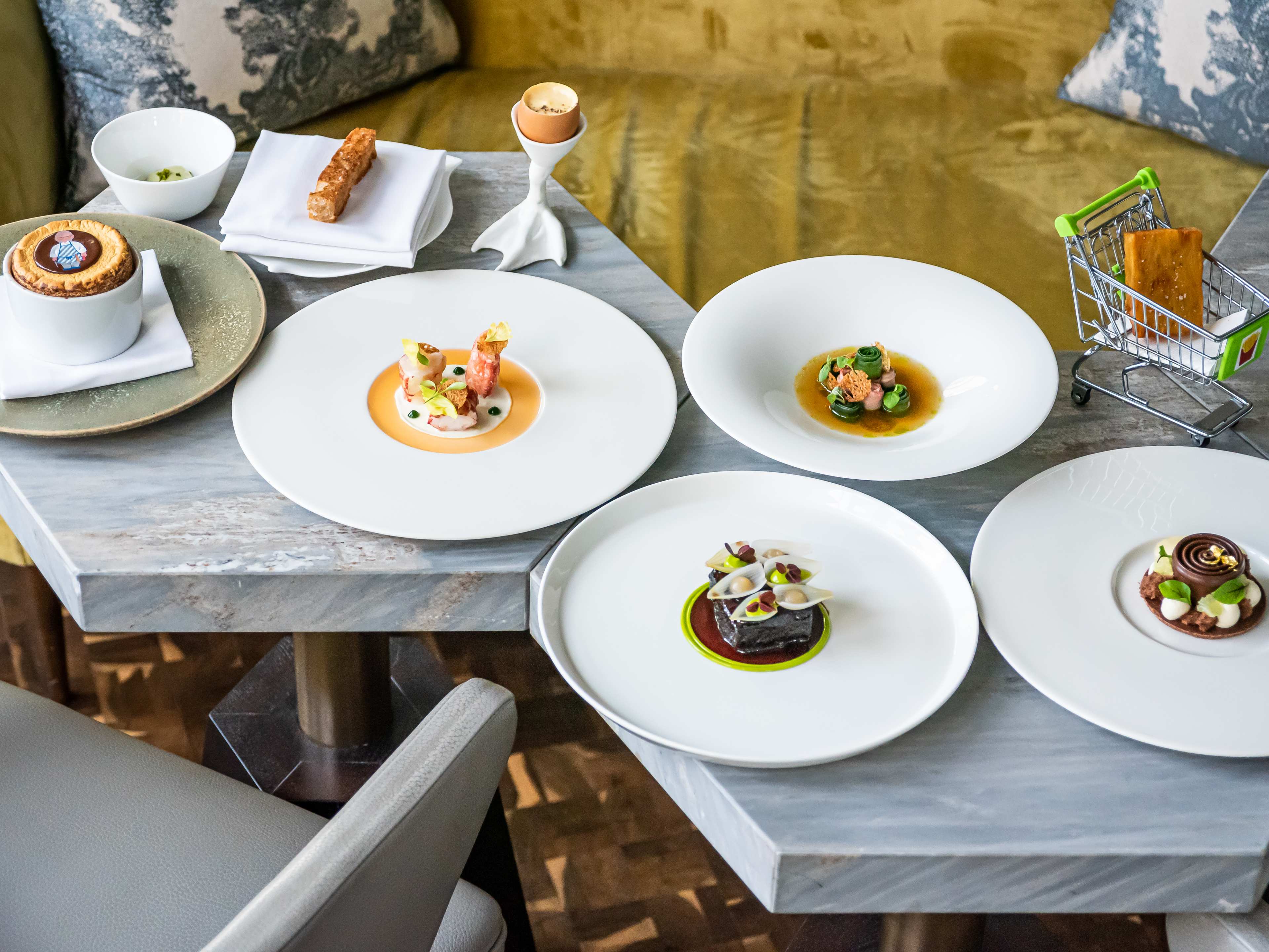 A spread of dishes on a geometric marble table at Launceston Place.