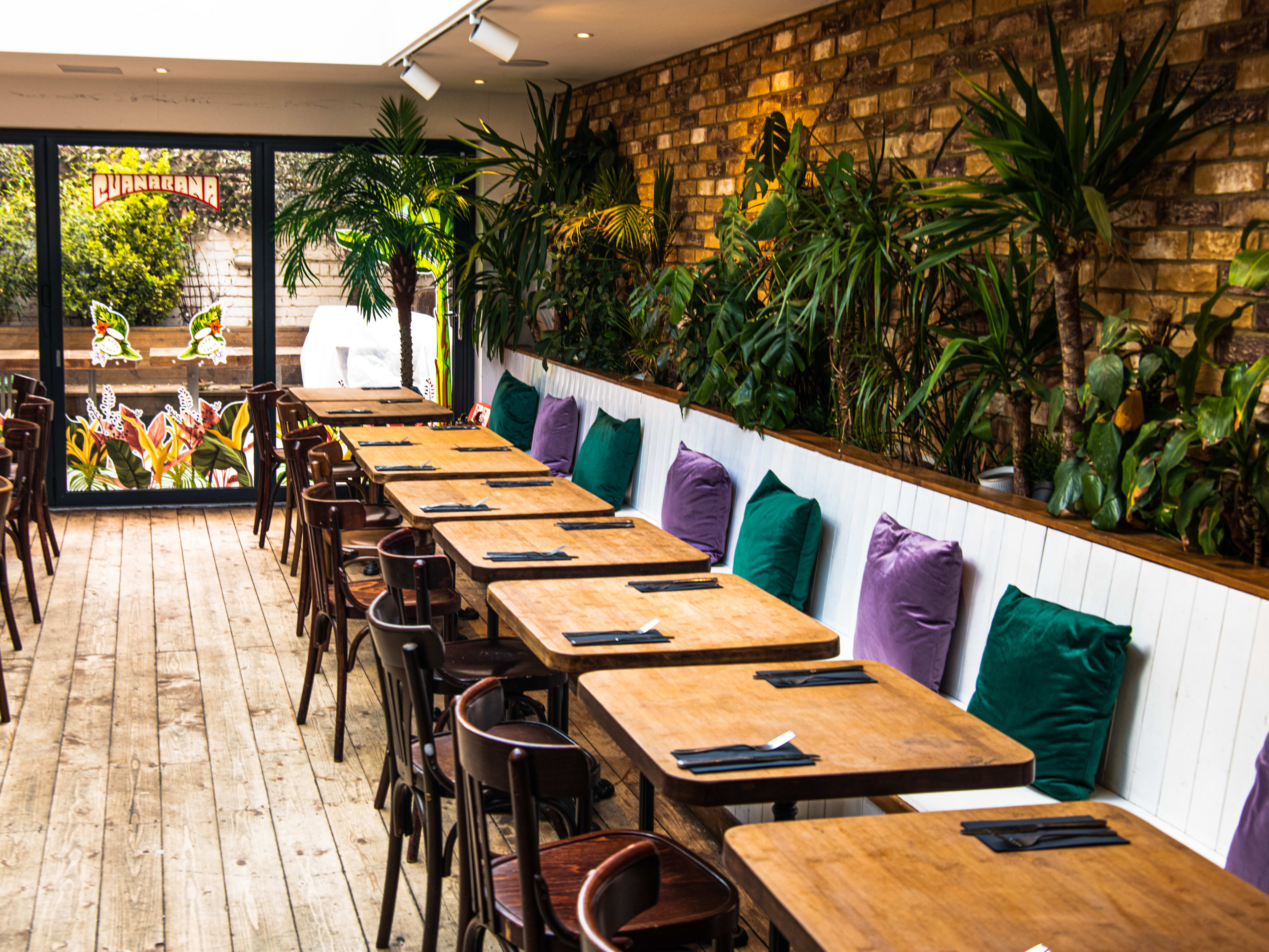 The plant filled interior of Guanabana. There is a back patio with more seating as well.