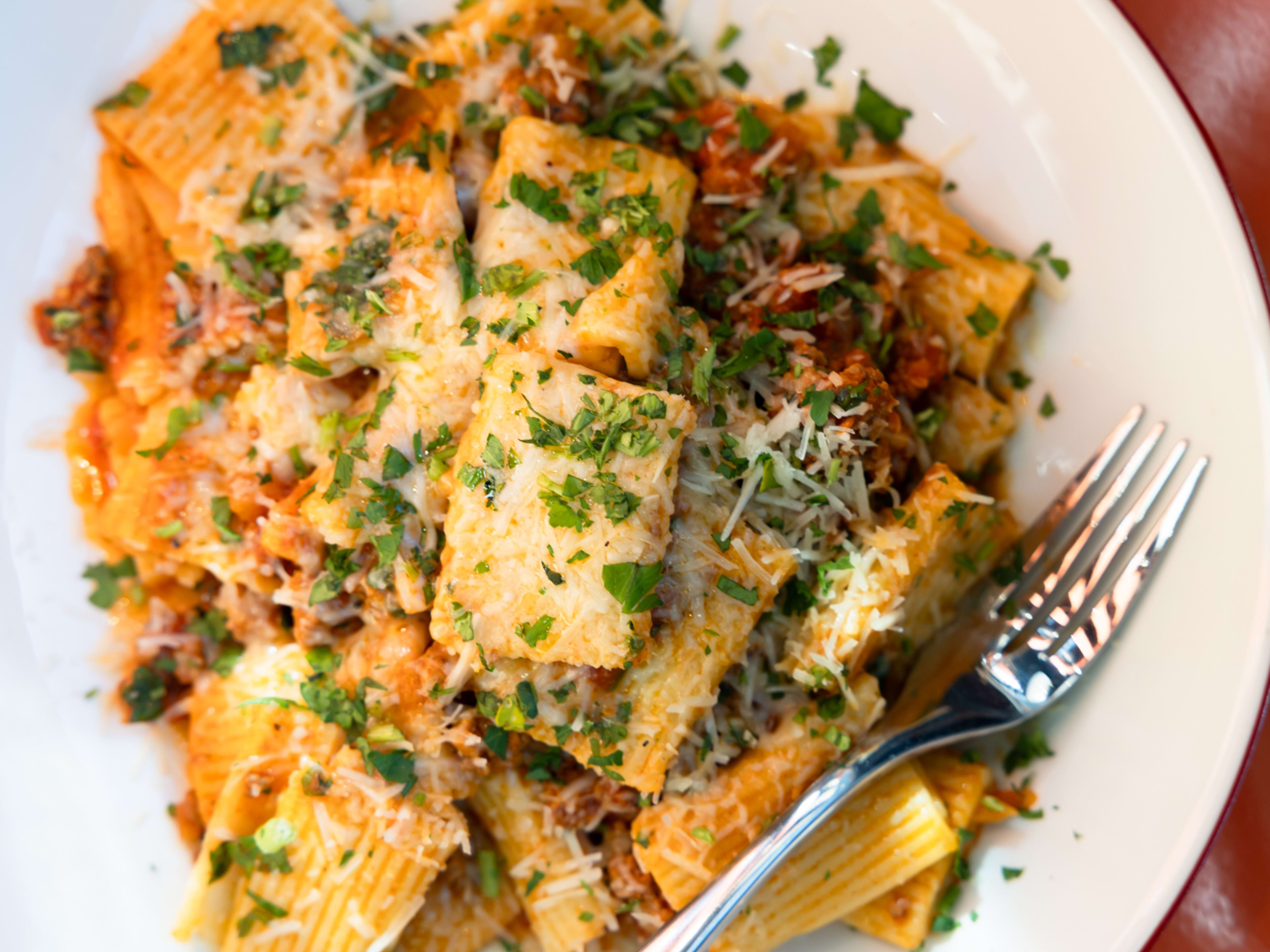 A pile of lamb ragu sits on a white plate.