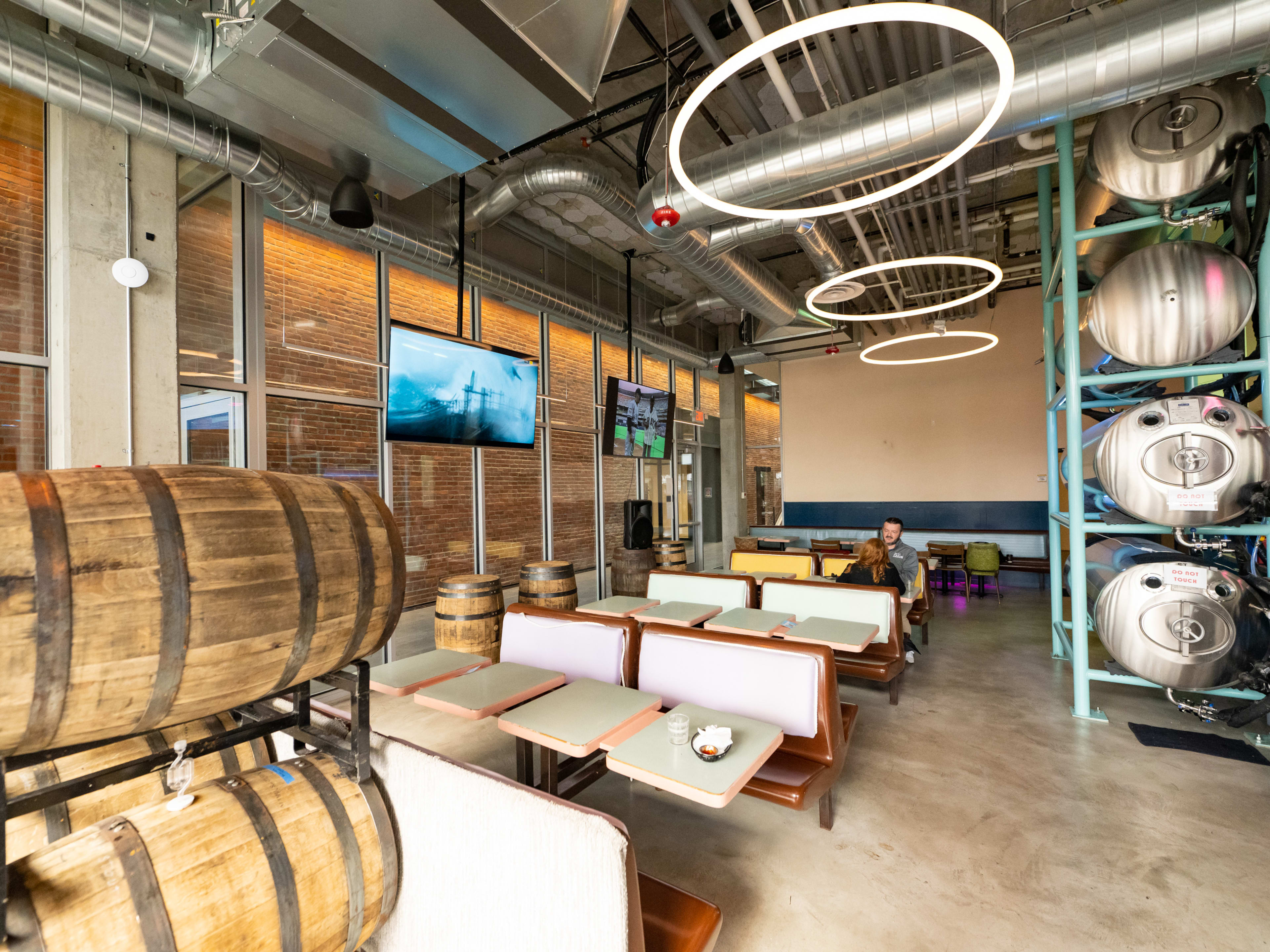 Brewery taproom with retro booths and decorative barrels