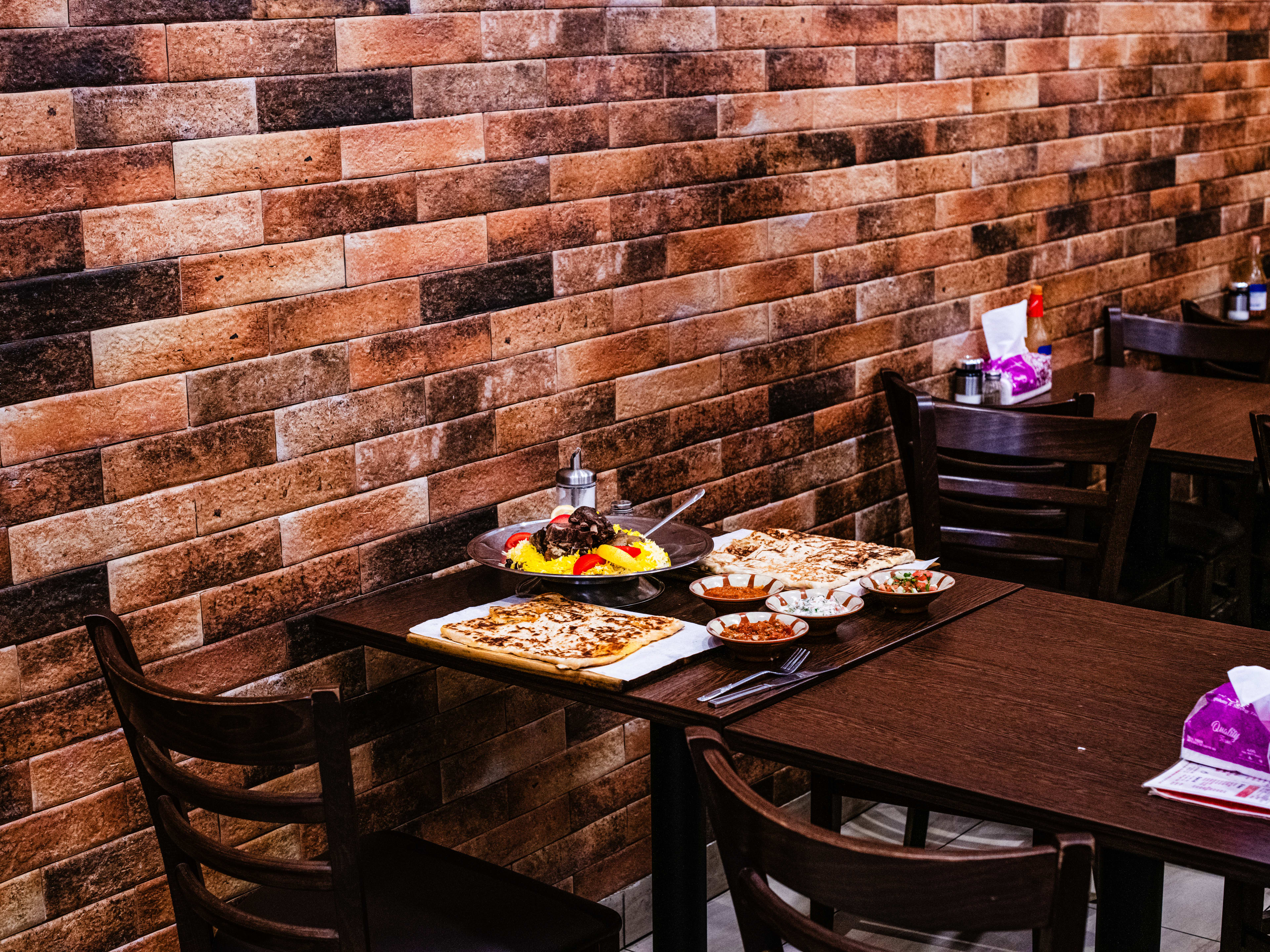 A pulled-back image of Yemeni dishes on a wooden table.