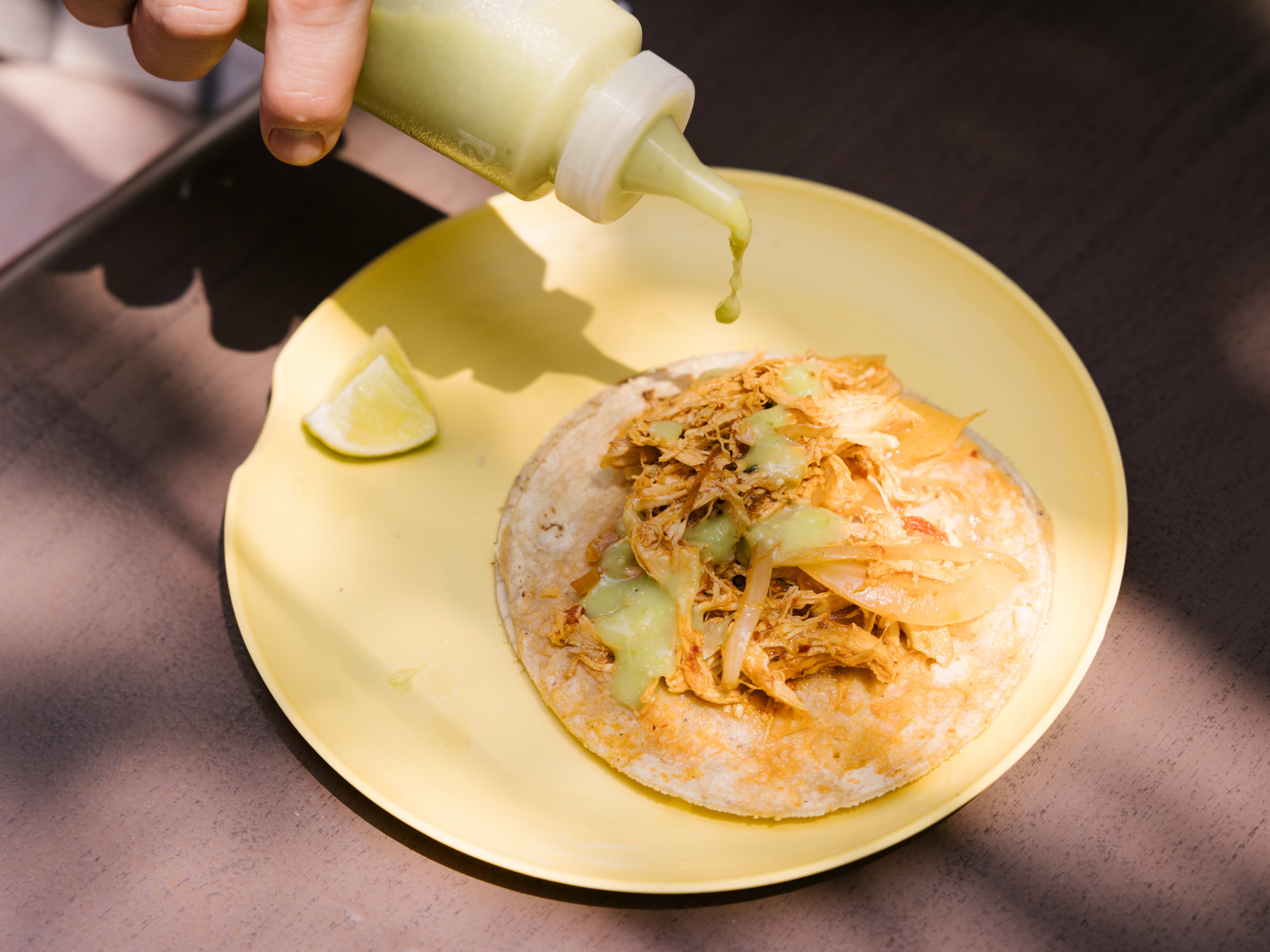 Tacos and salsa on a table at Tacos Hola el Güero