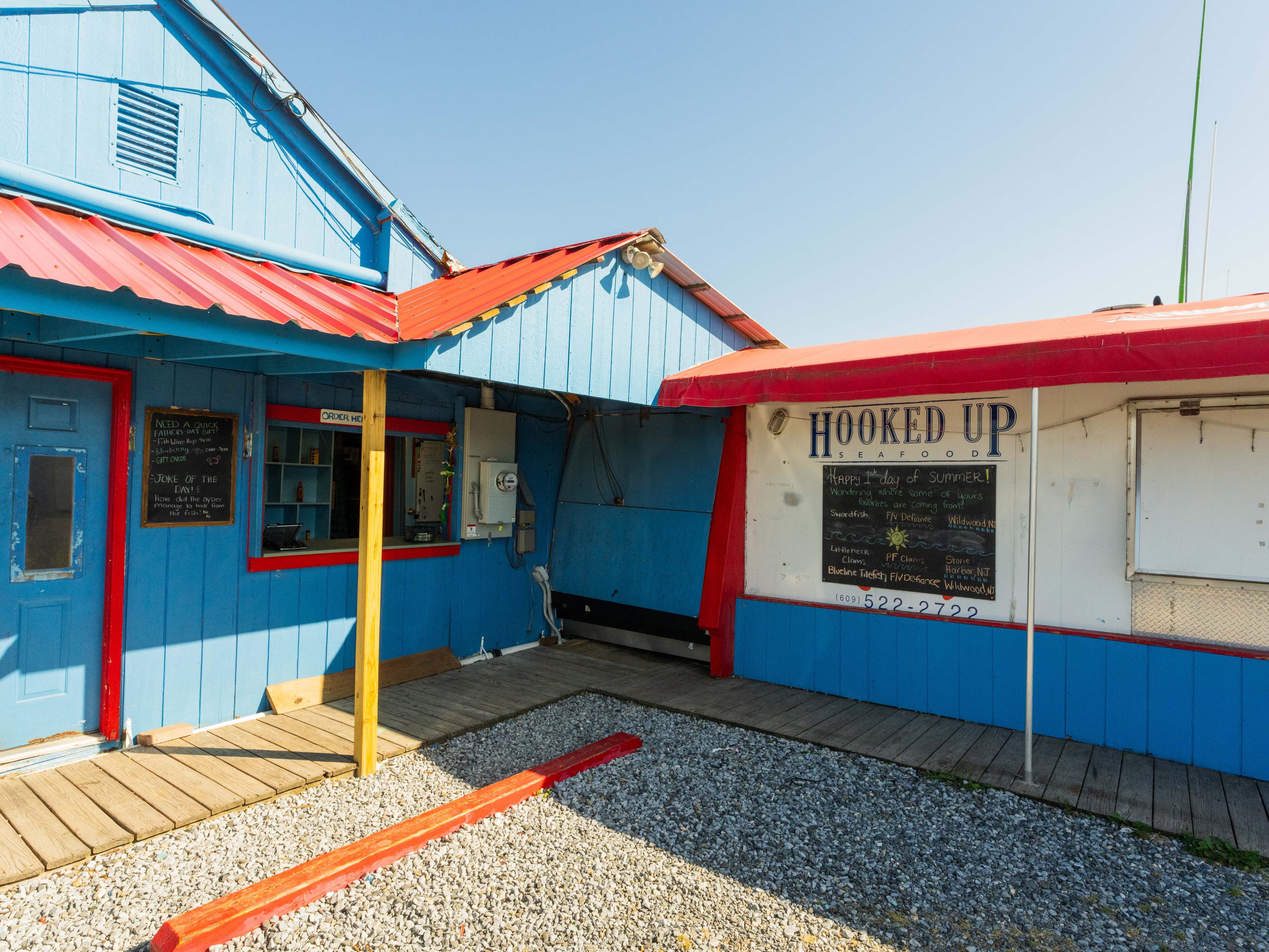 The blue and red exterior of Hooked Up Seafood in Cape May