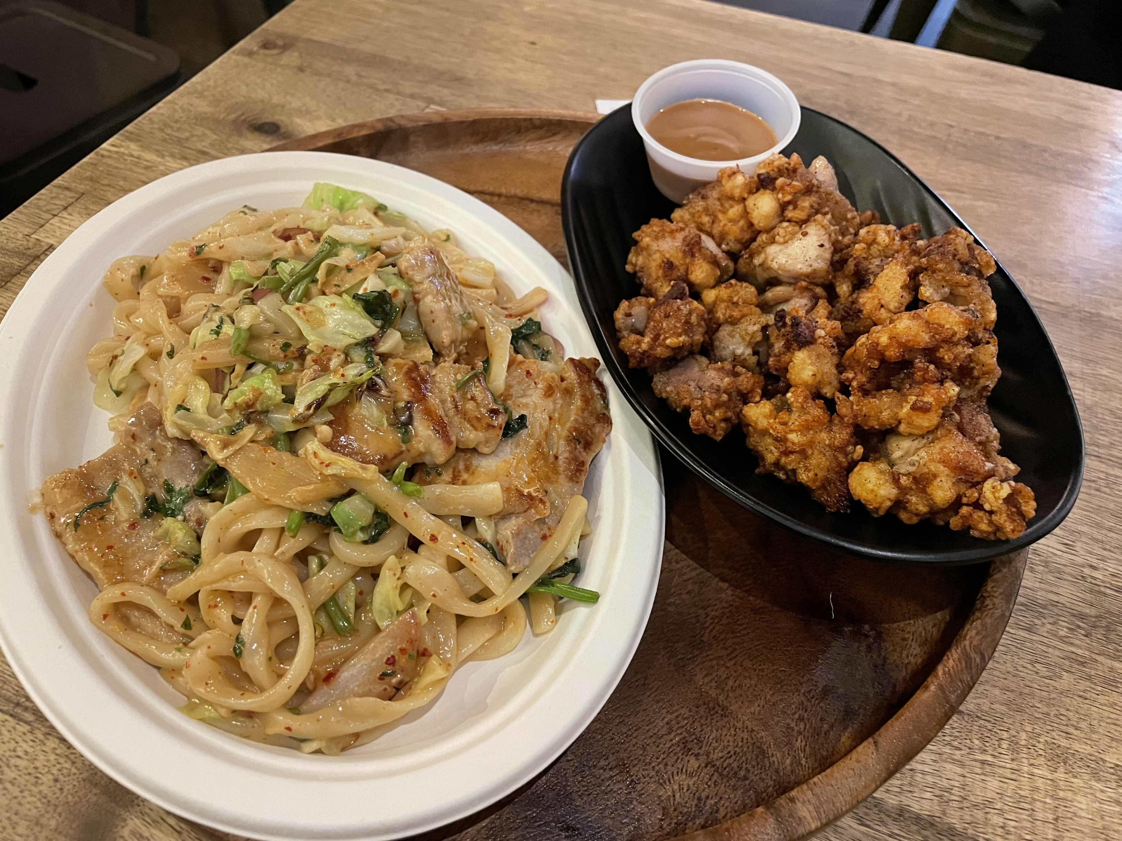 a plate of noodles with pork belly, and a plate of karaage