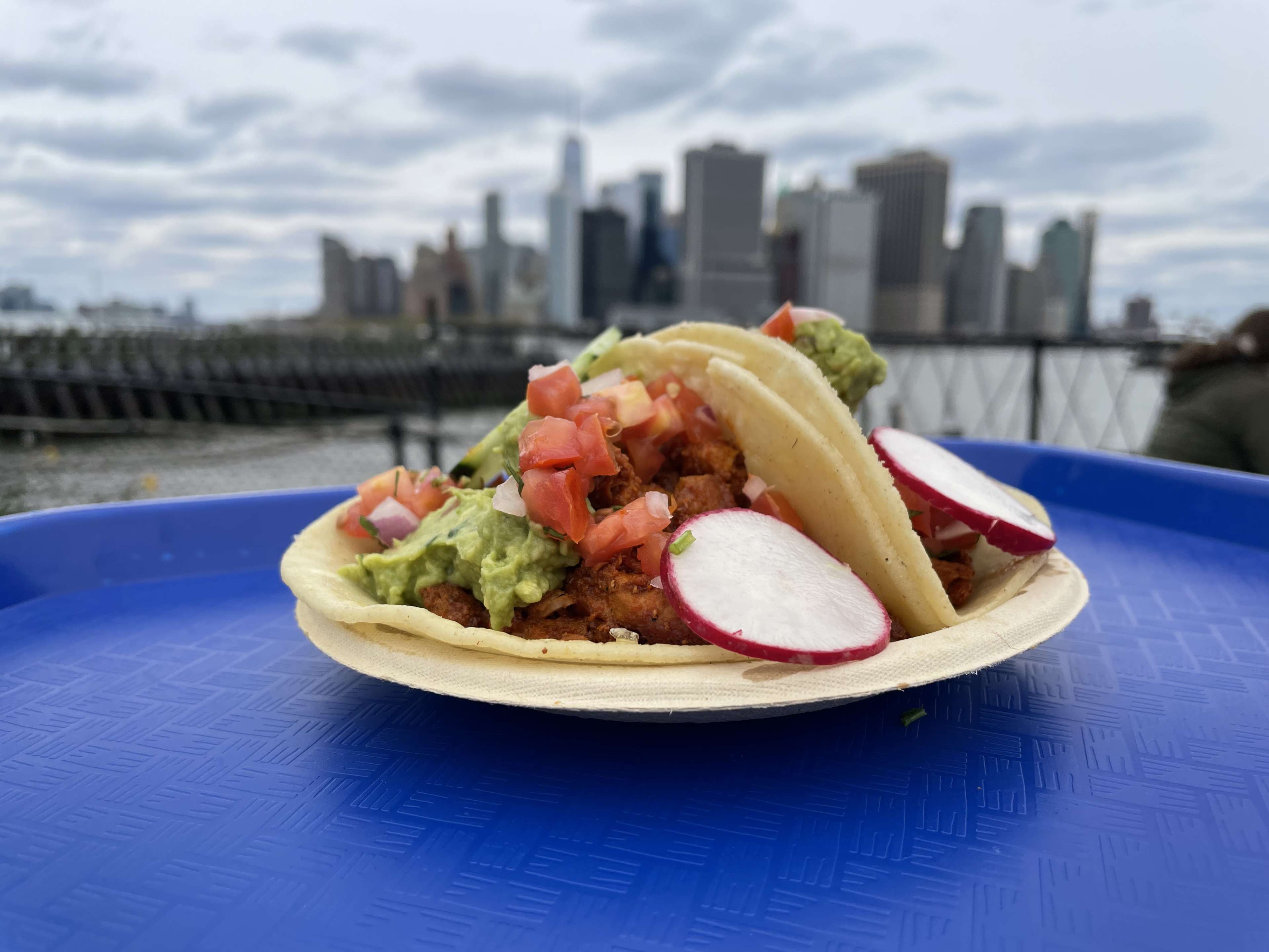 two tacos with a background of the New York City skyline