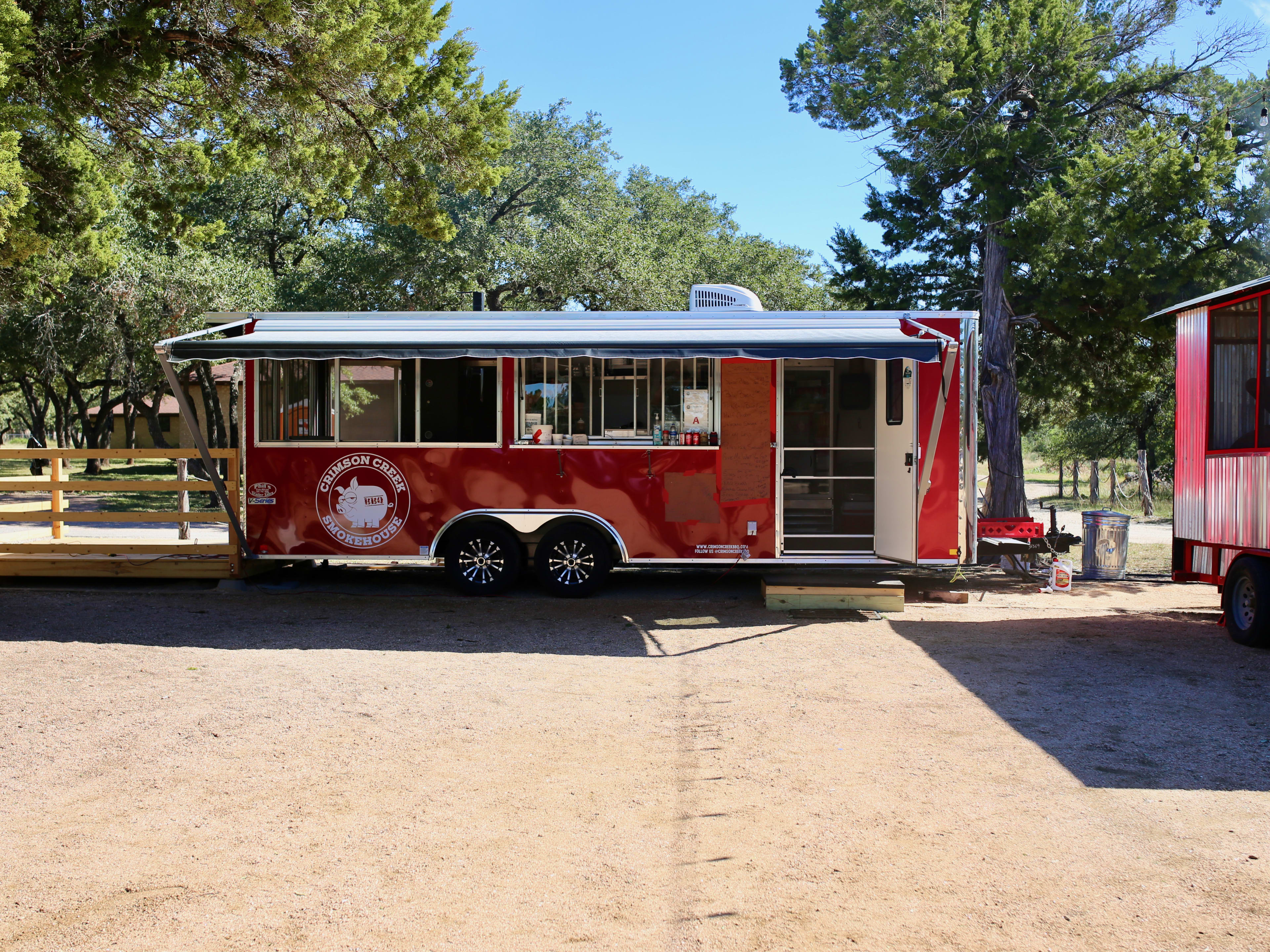 The red Crimson Creek Smokehouse food truck.