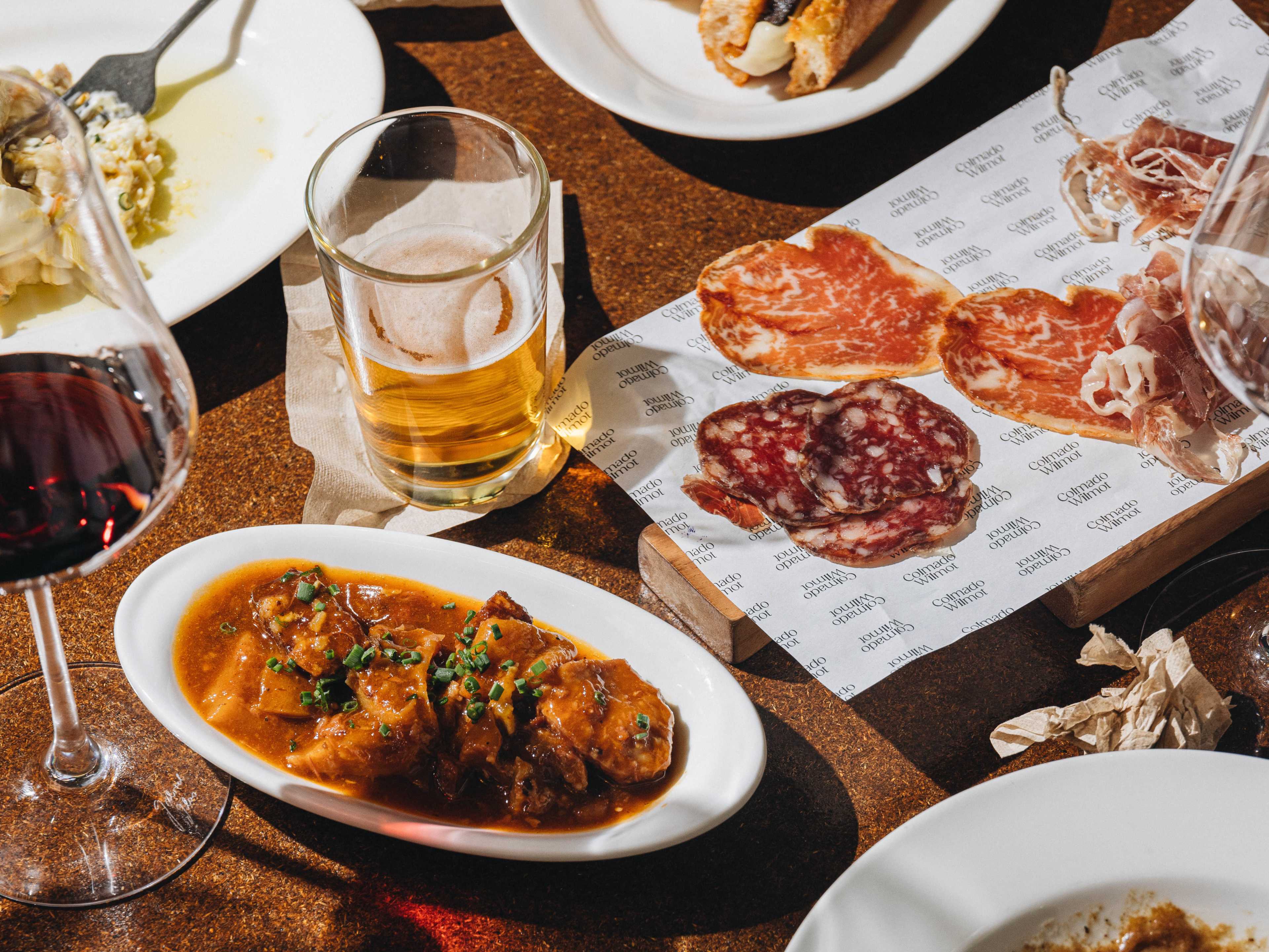 Spread of charcuterie, tapas, and wine at Colmado Wilmot