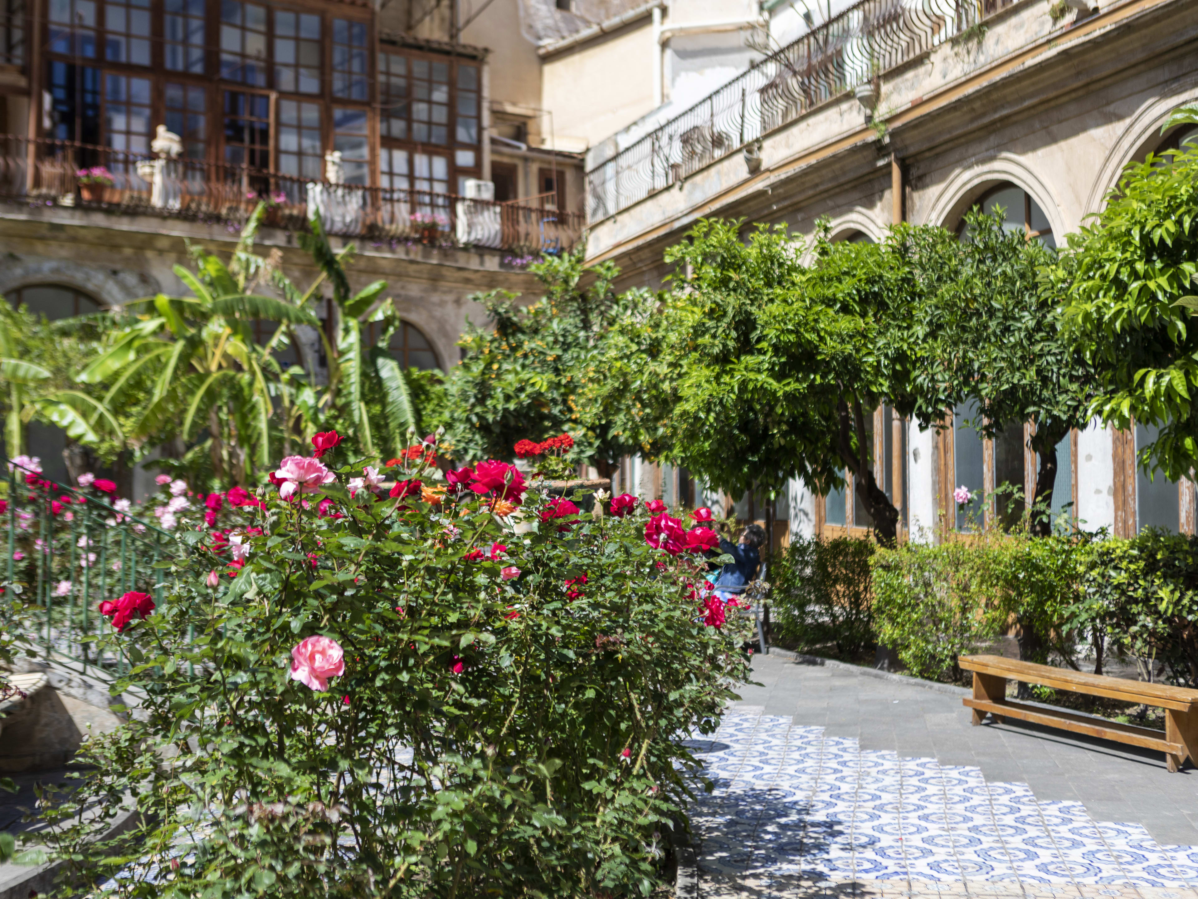 Green garden space with outdoor seating at I Segreti del Chiostro