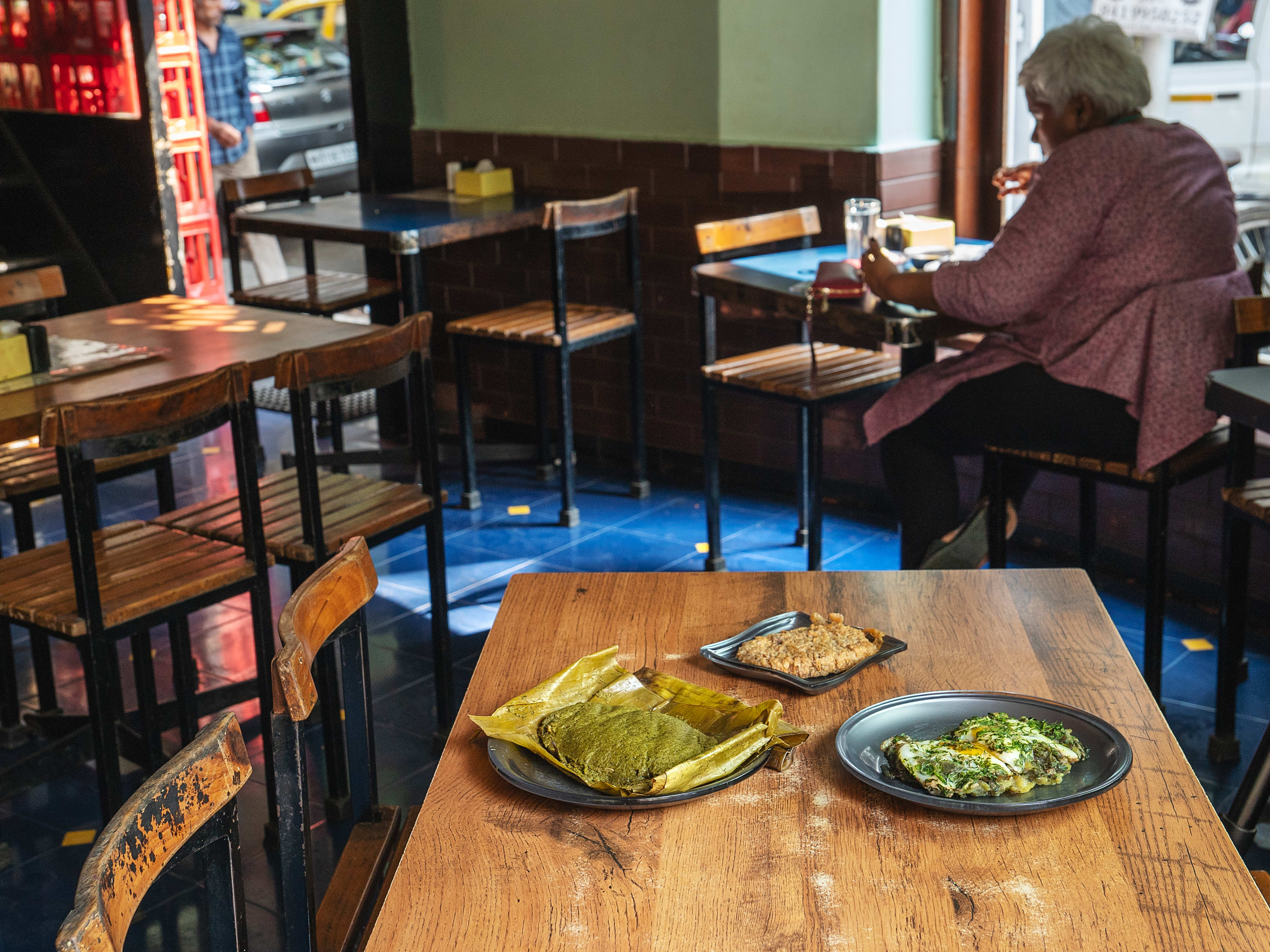 Spread of dishes on wooden table at Ideal Corner