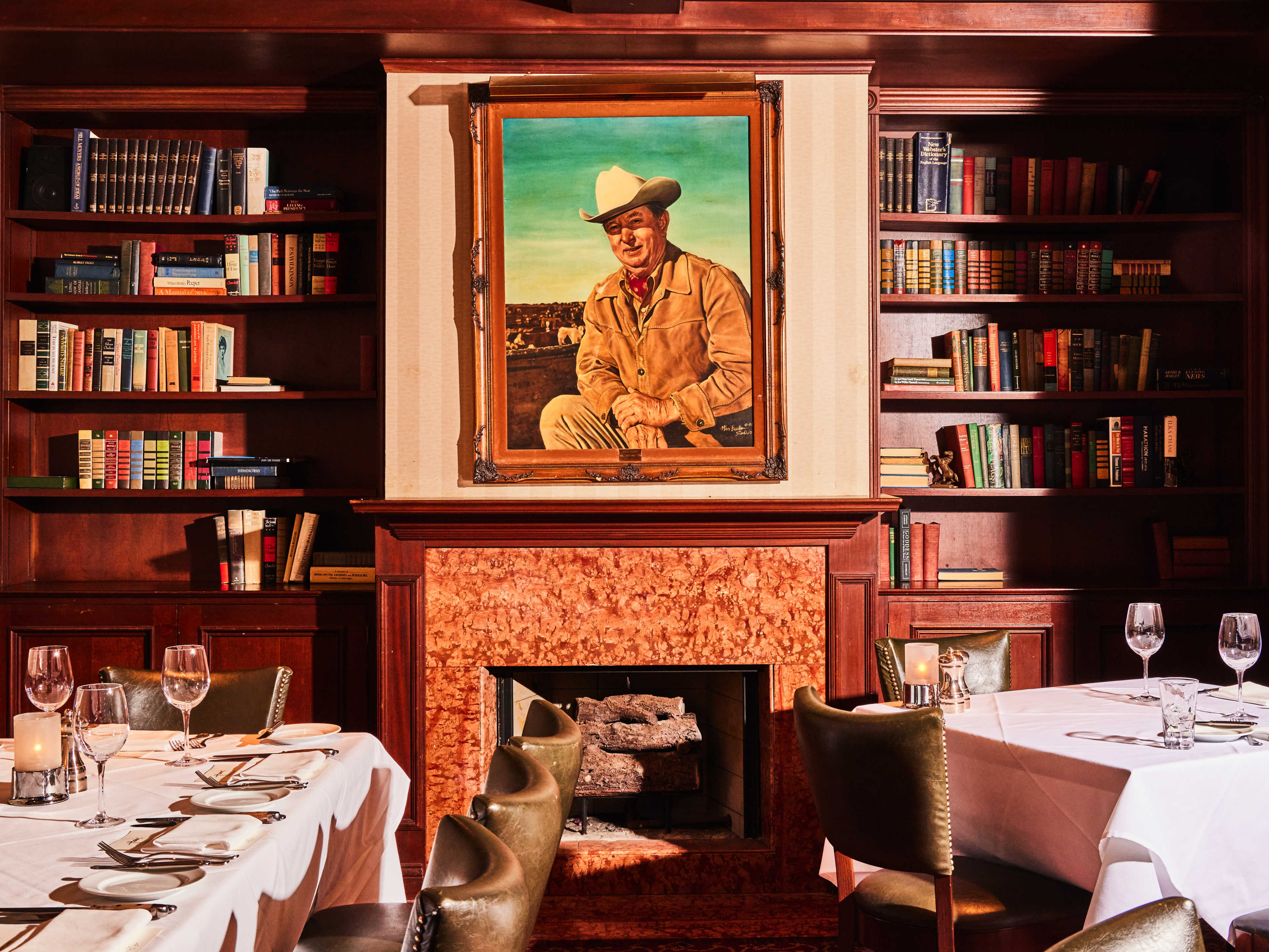 The interior dining room with bookshelves and a fireplace at Harris' Restaurant