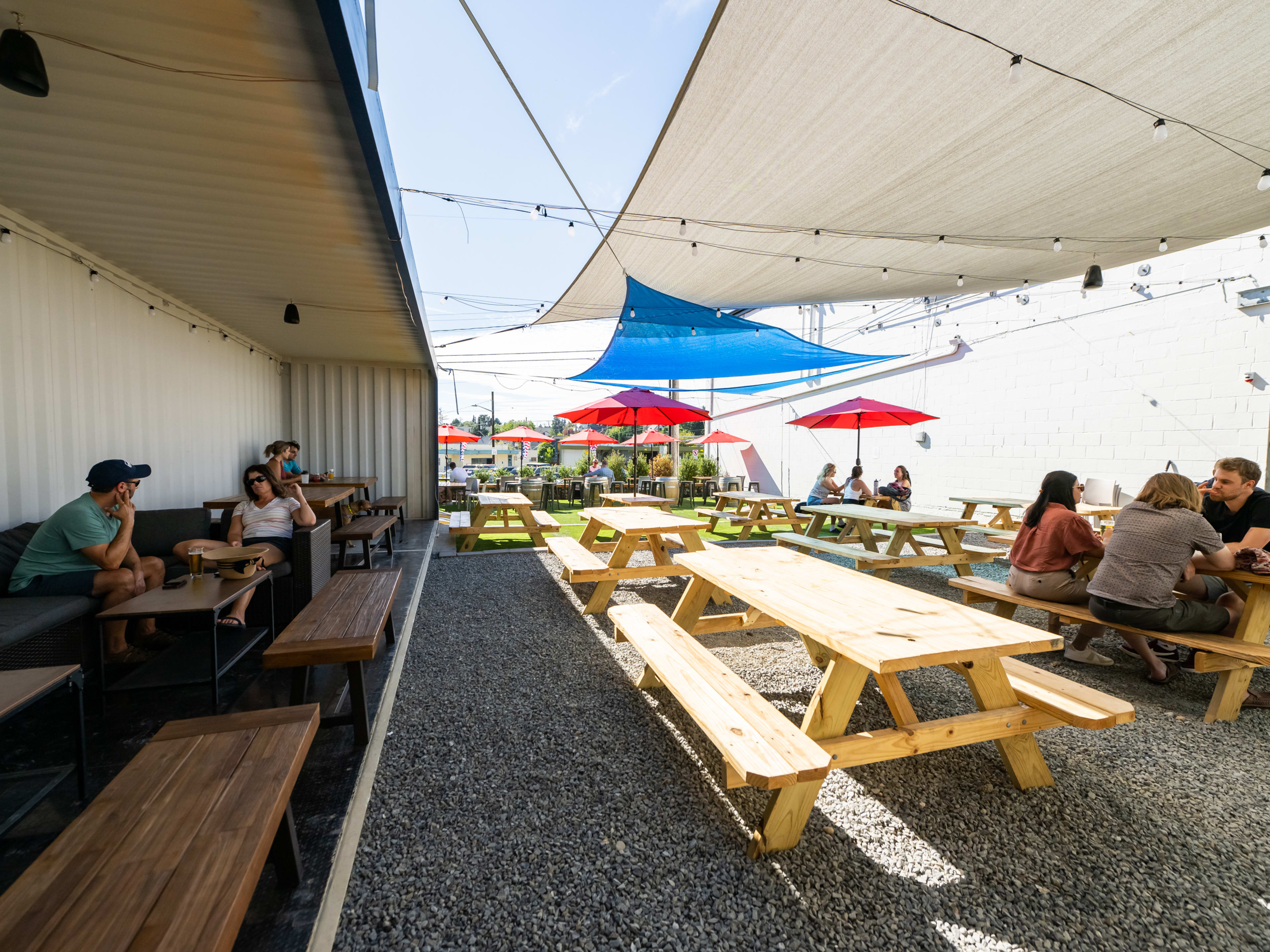 outdoor area with shaded tables and picnic tables in the sun