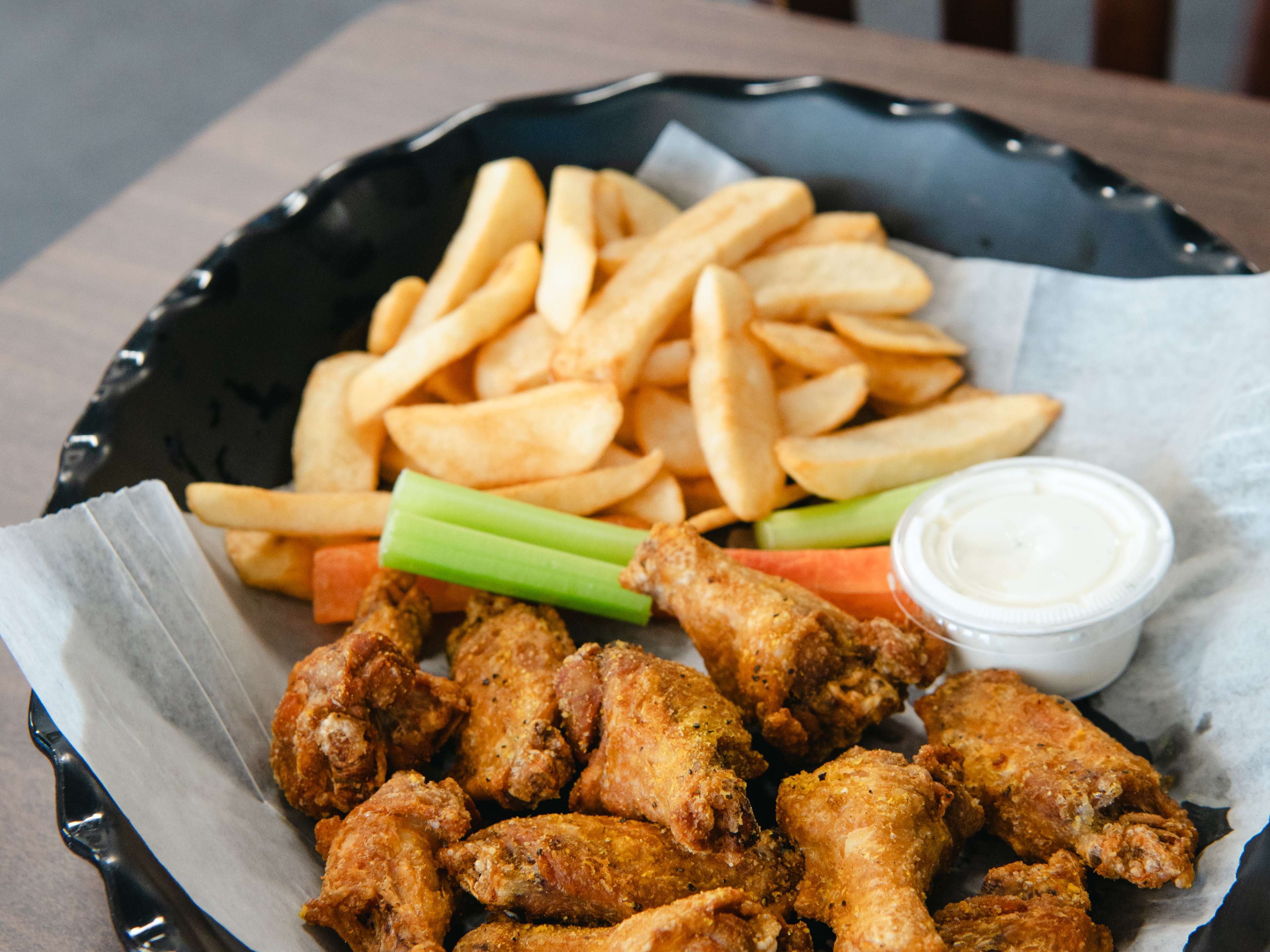 A basket of wings and french fries.