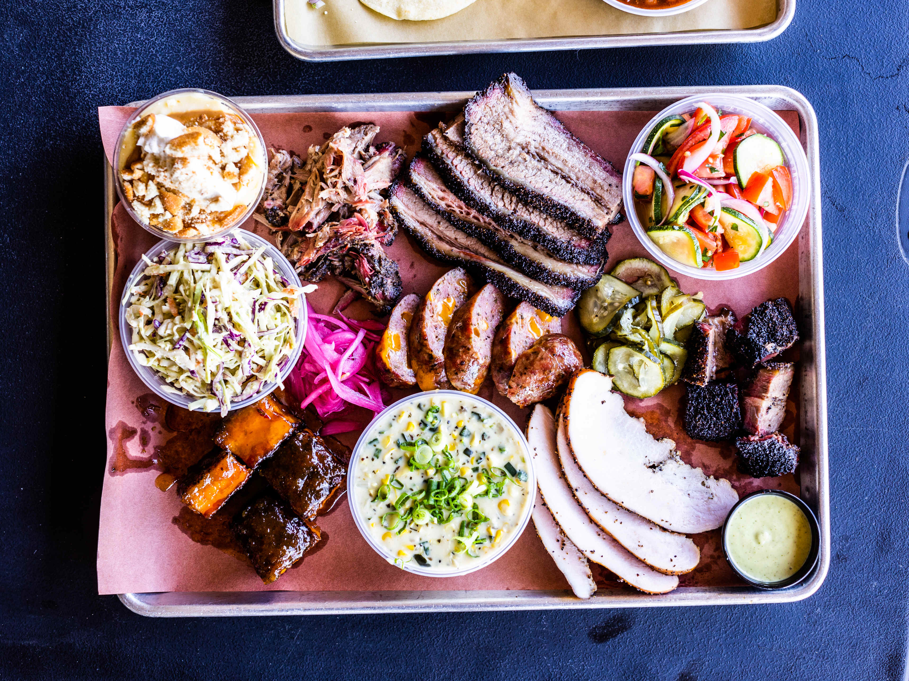 A bbq spread on a tray from Interstellar BBQ.