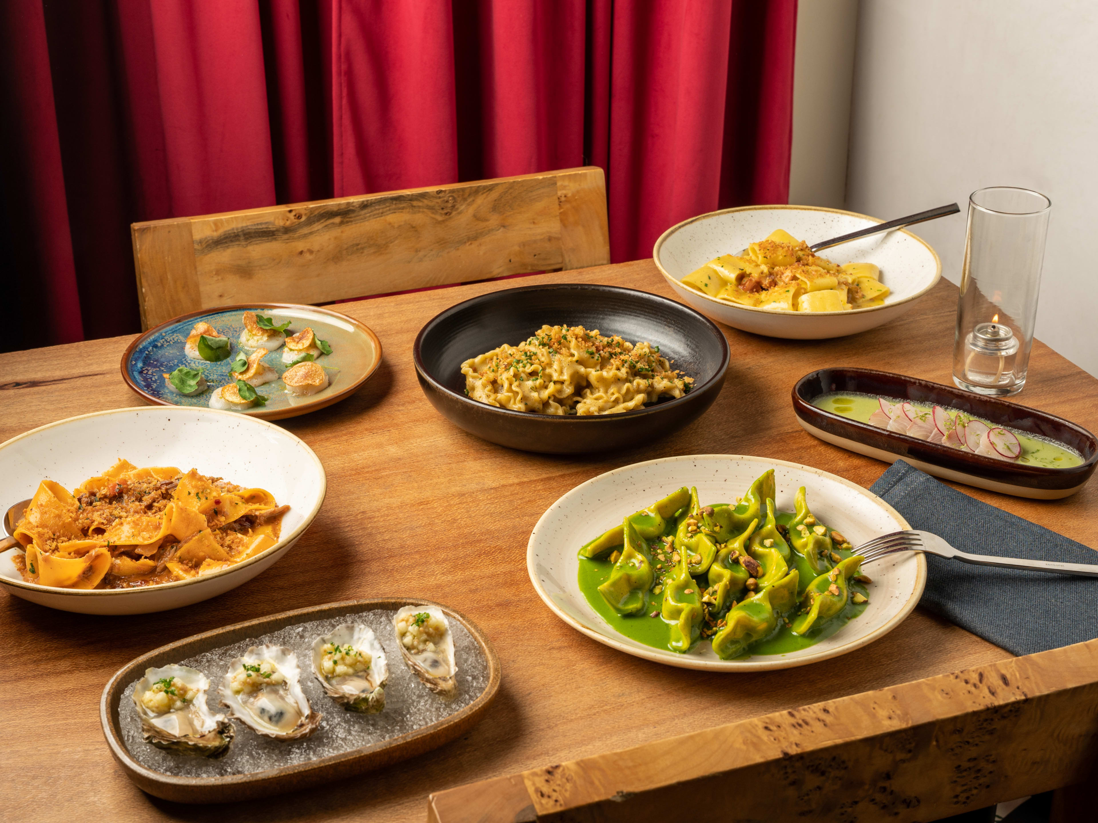 spread of pasta and seafood dishes