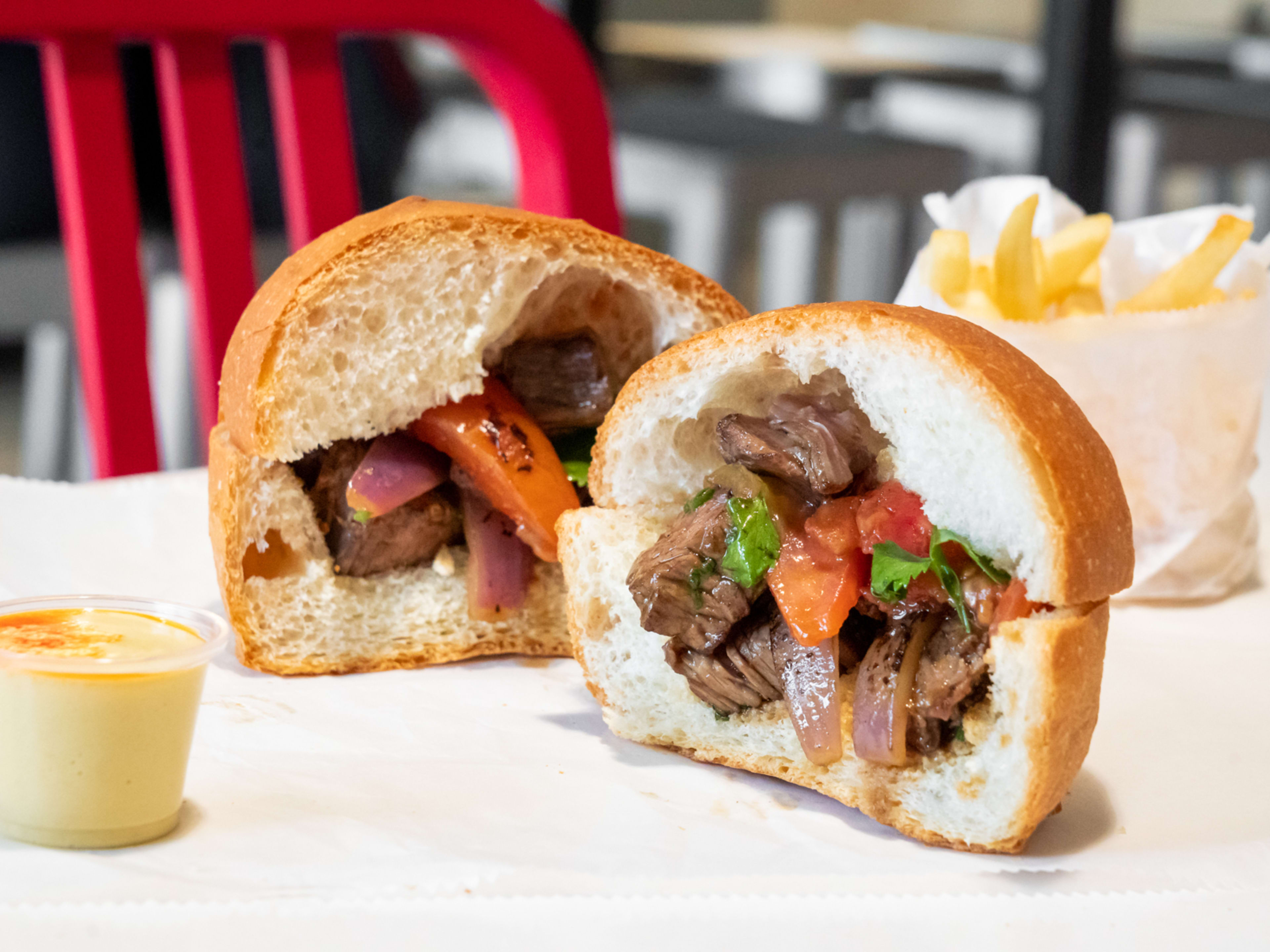 A cross section of the lomo saltado sandwich.