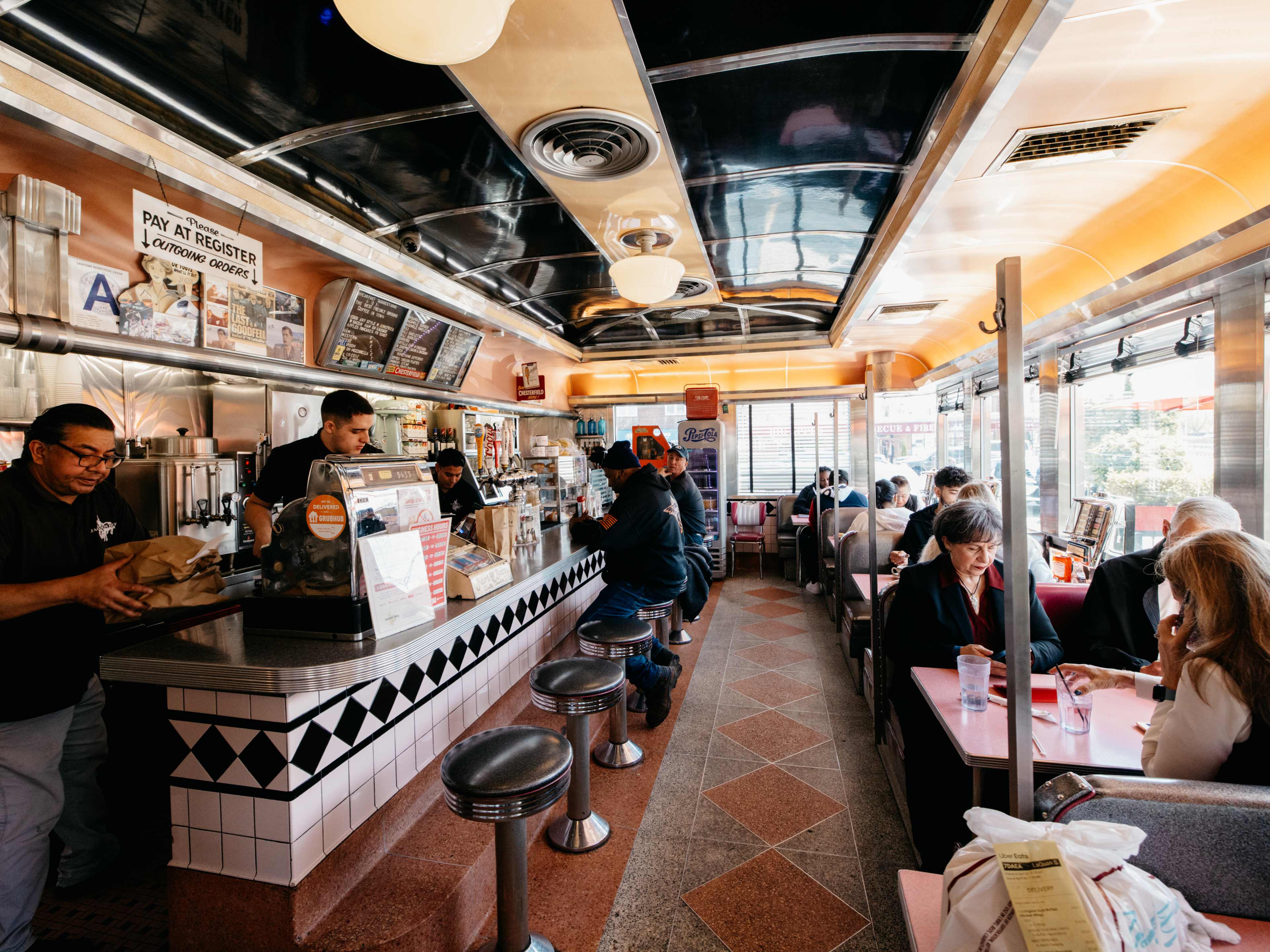Diners and staff inside Jackson Hole during the daytime.