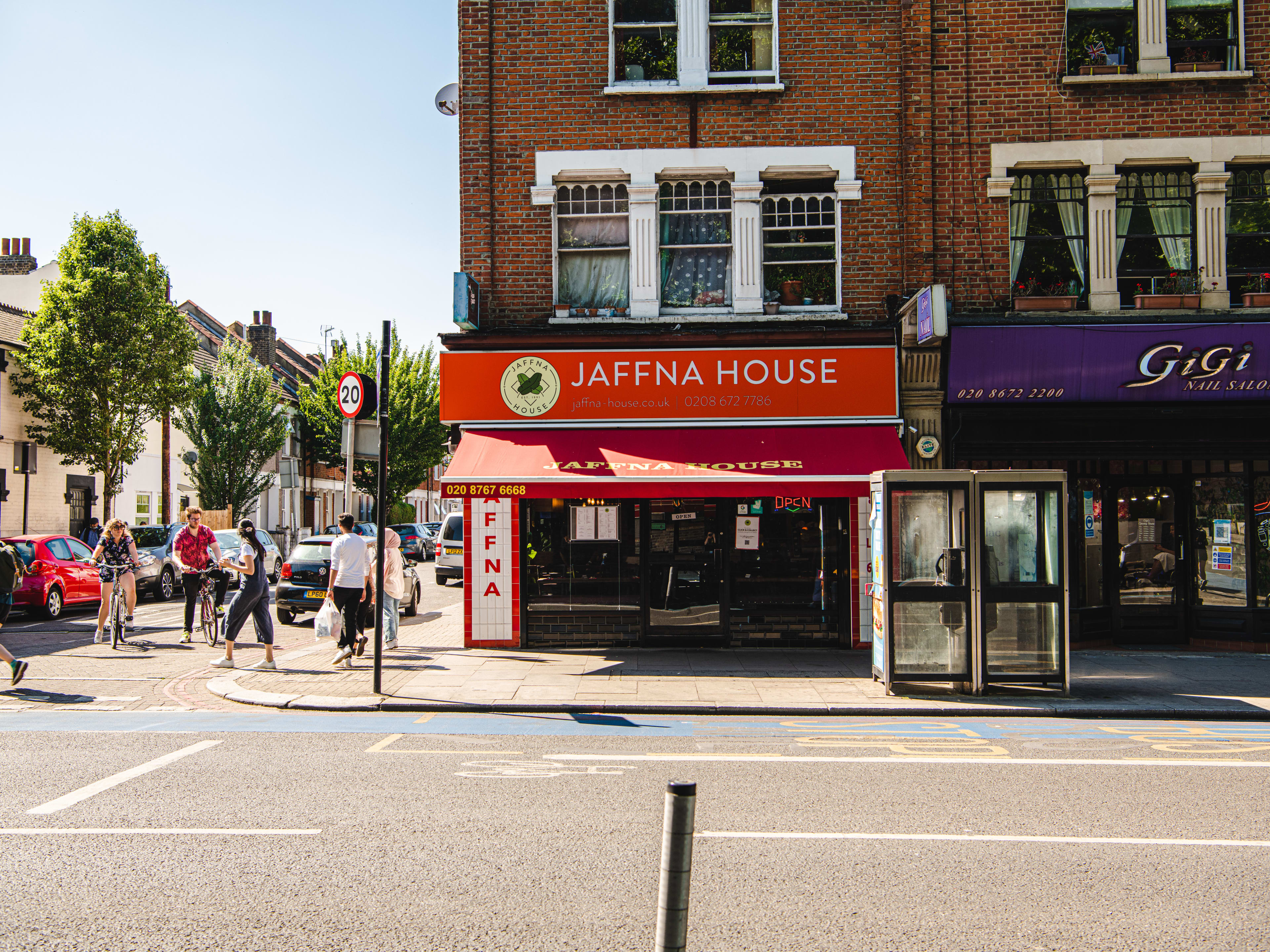 Red restaurant exterior with the words 'Jaffna House' in white.