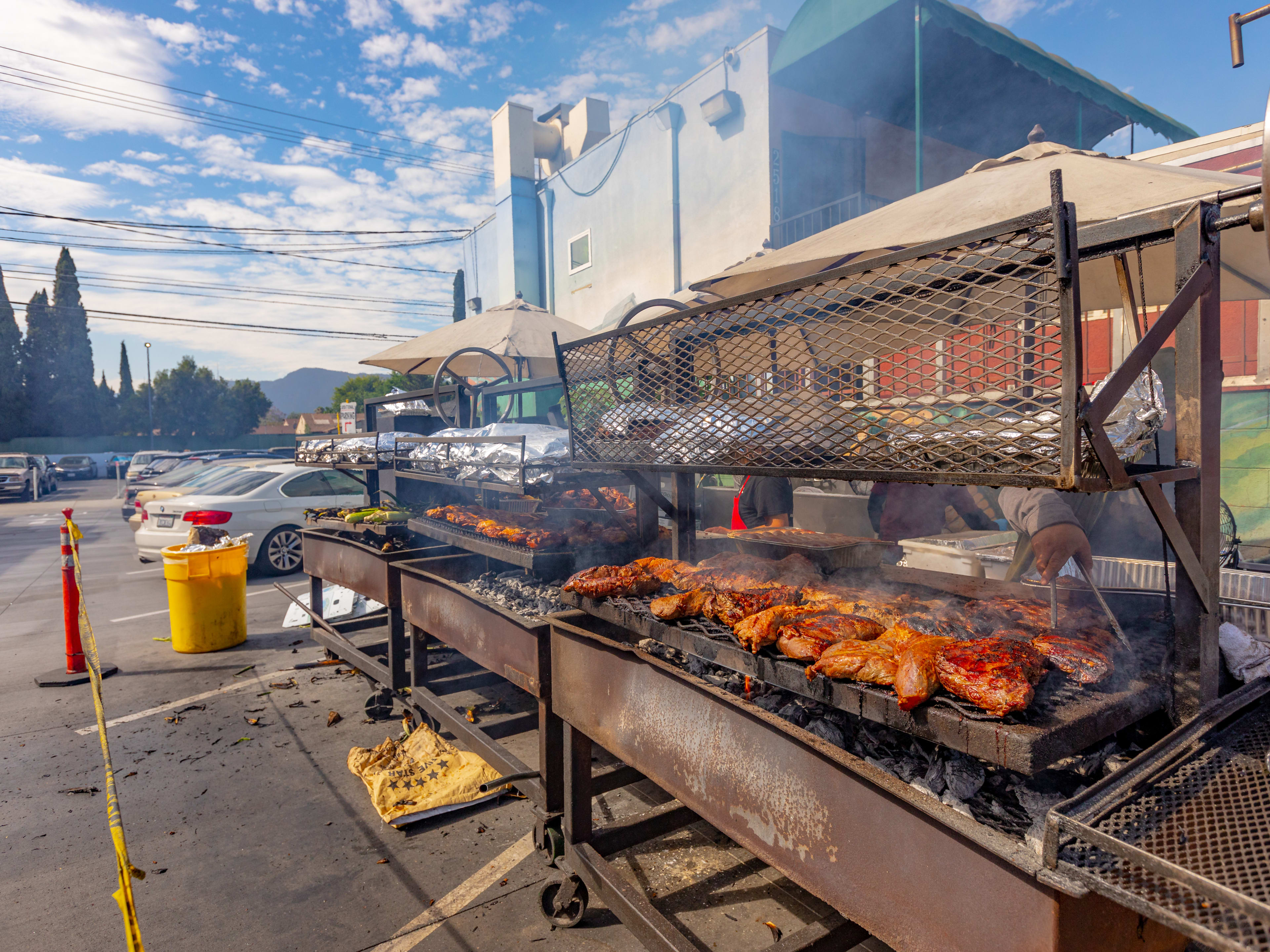 barbecue grilling on three grills outside of Handy Market.