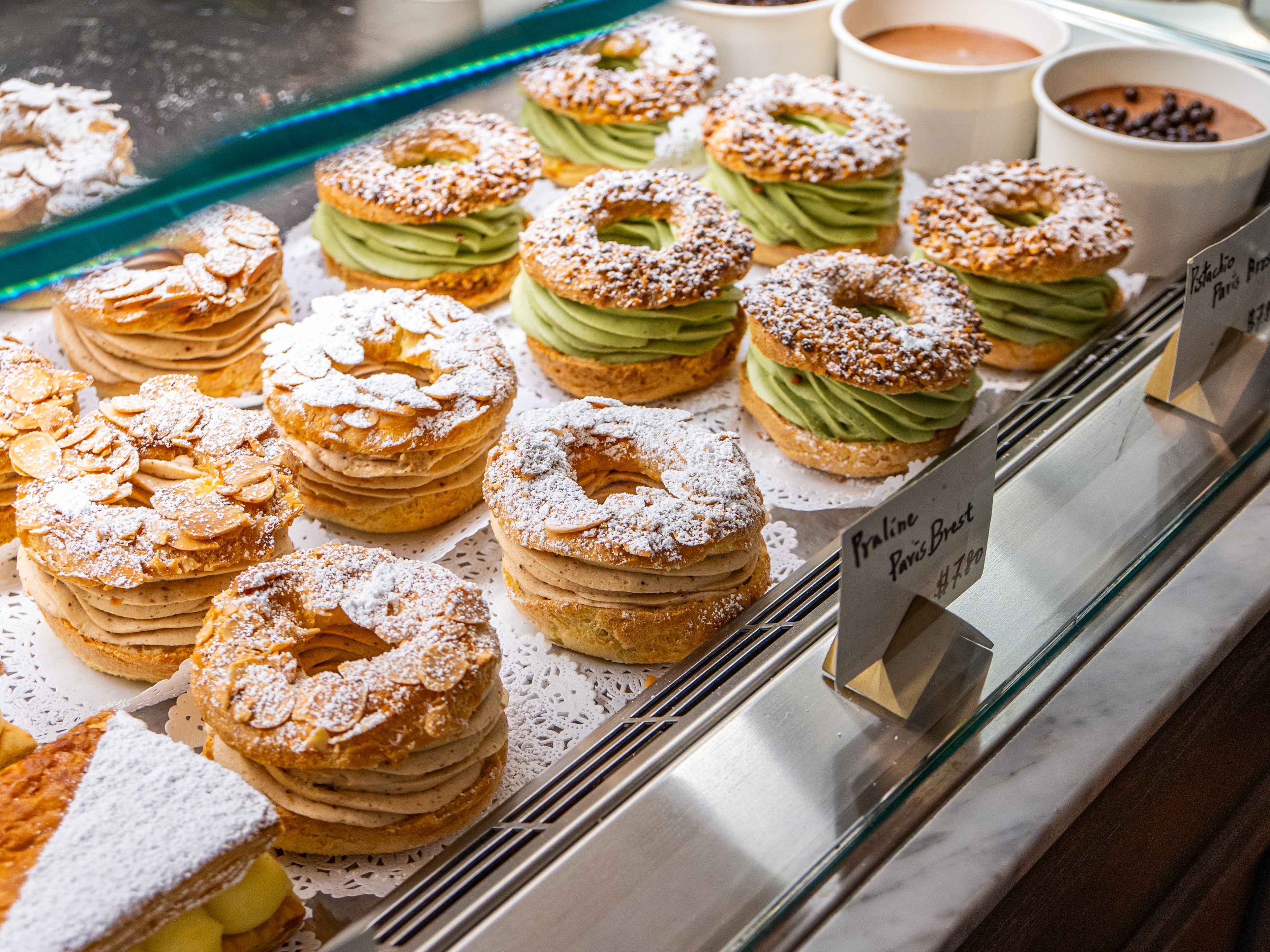 close up shot of cream-filled pastries in display case