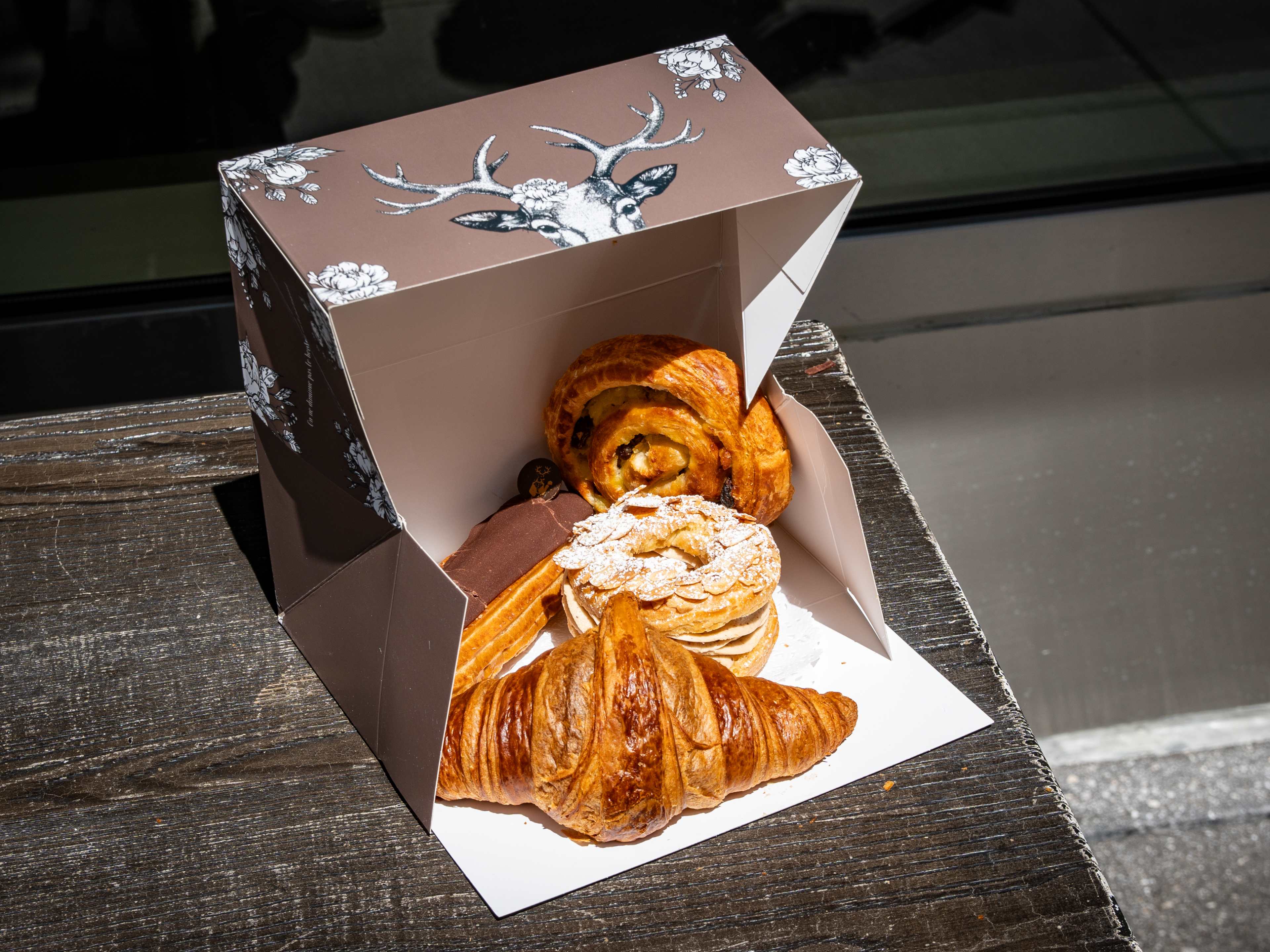 open box of pastries on outdoor table