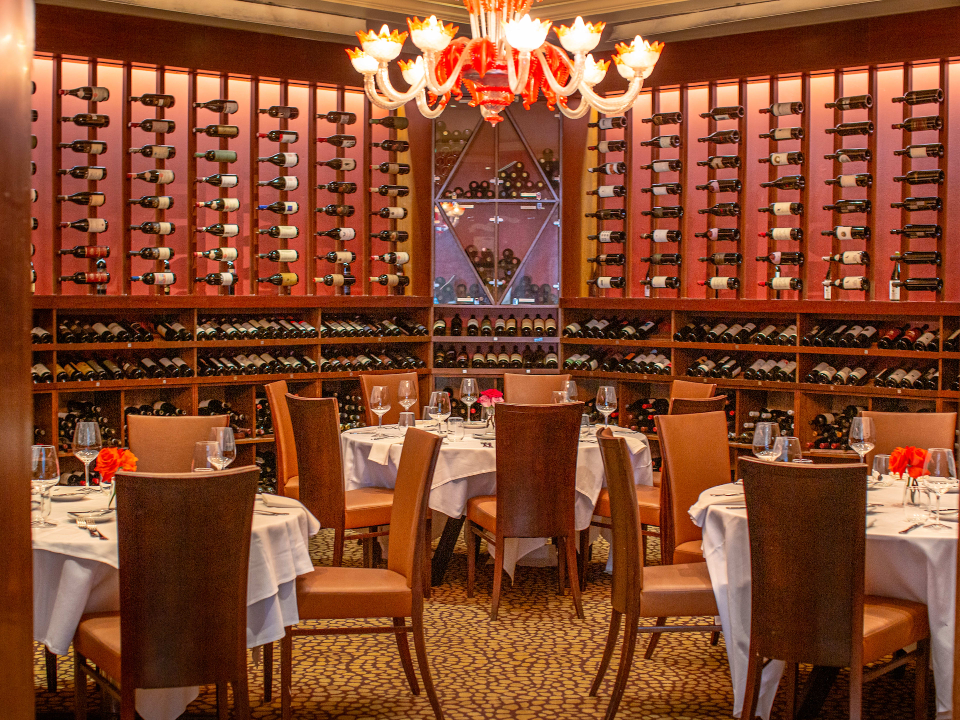 dining room with a floor to ceiling wall of wine bottle storage