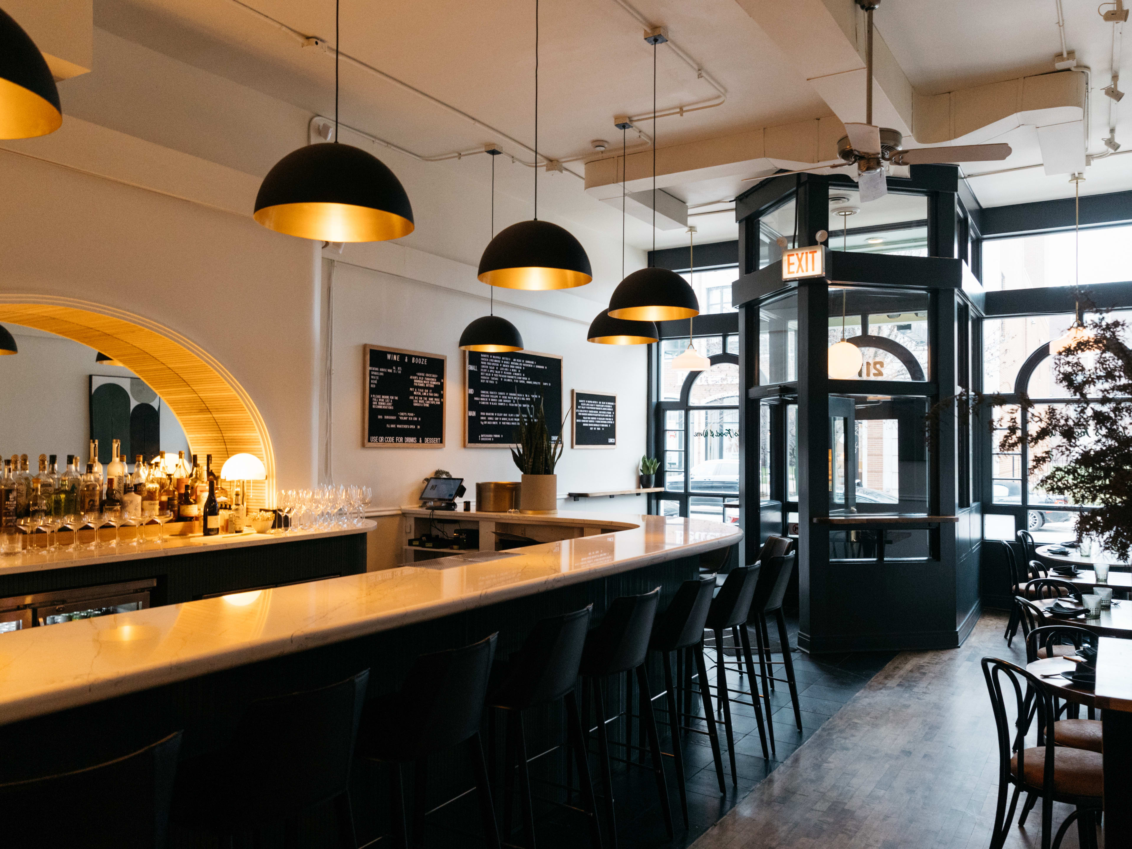 Front dining room at John's Food And Wine with a bar running down the left side