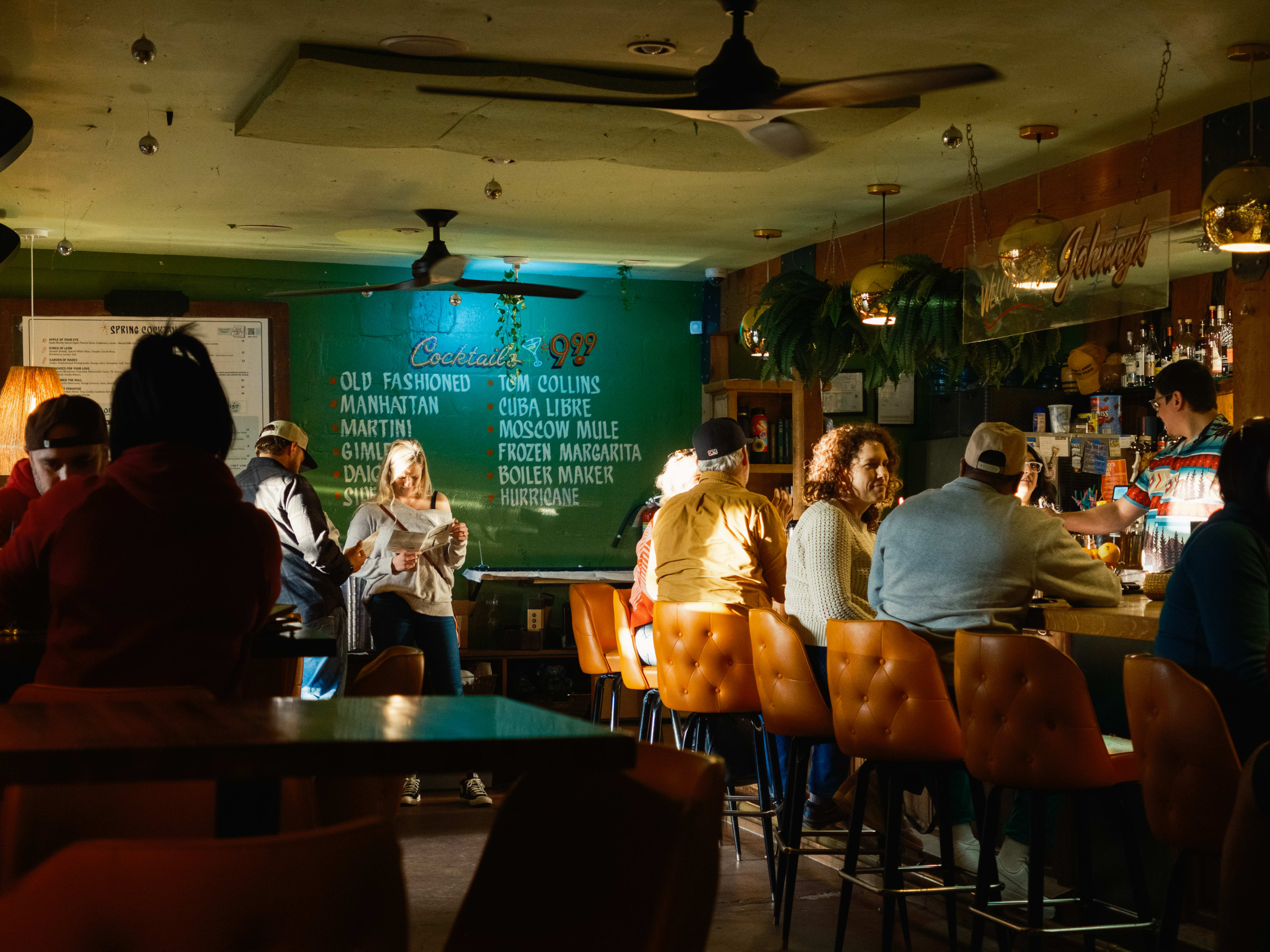 People sitting at the bar and at tables at Johnny's Gold Brick.