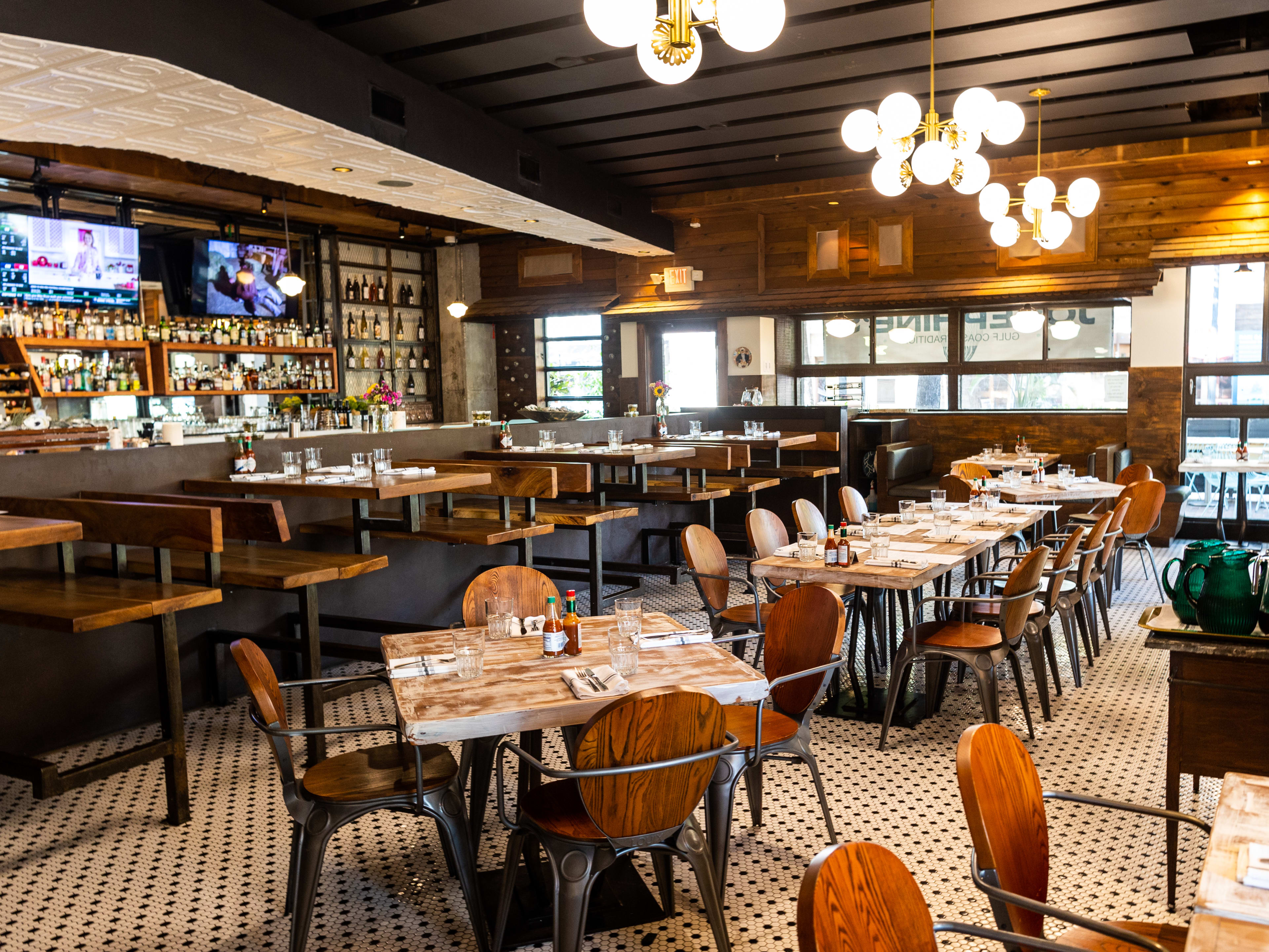 The interior of Josephine's with wooden, black and gold accents and a black and white tiled floor.